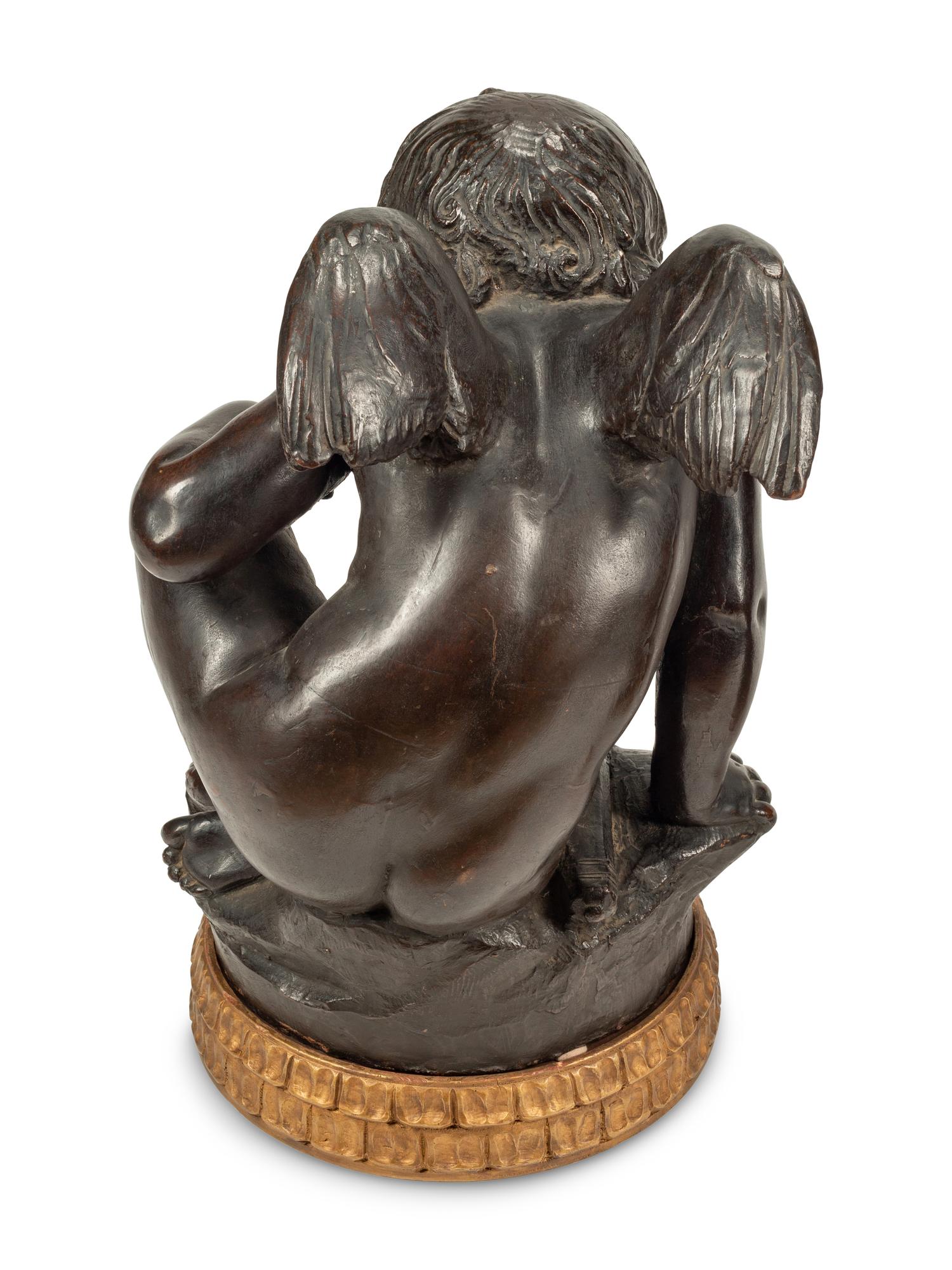 A Pair of Bronzed Composition Figures of Seated Cherubs