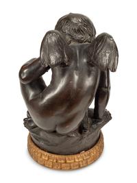 A Pair of Bronzed Composition Figures of Seated Cherubs
