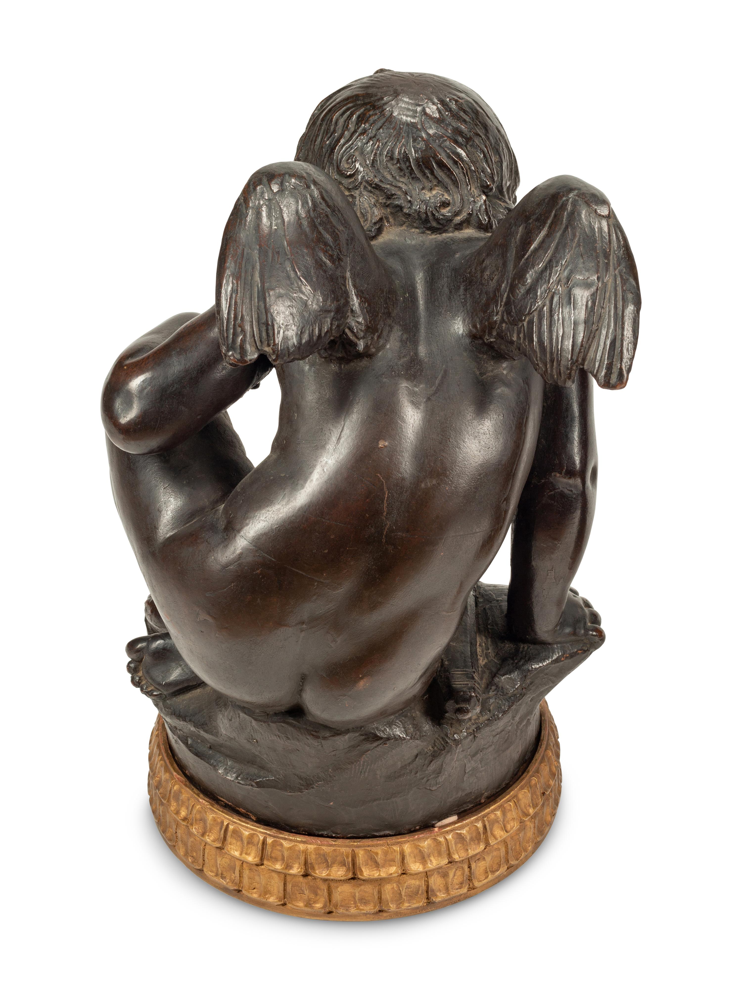 A Pair of Bronzed Composition Figures of Seated Cherubs