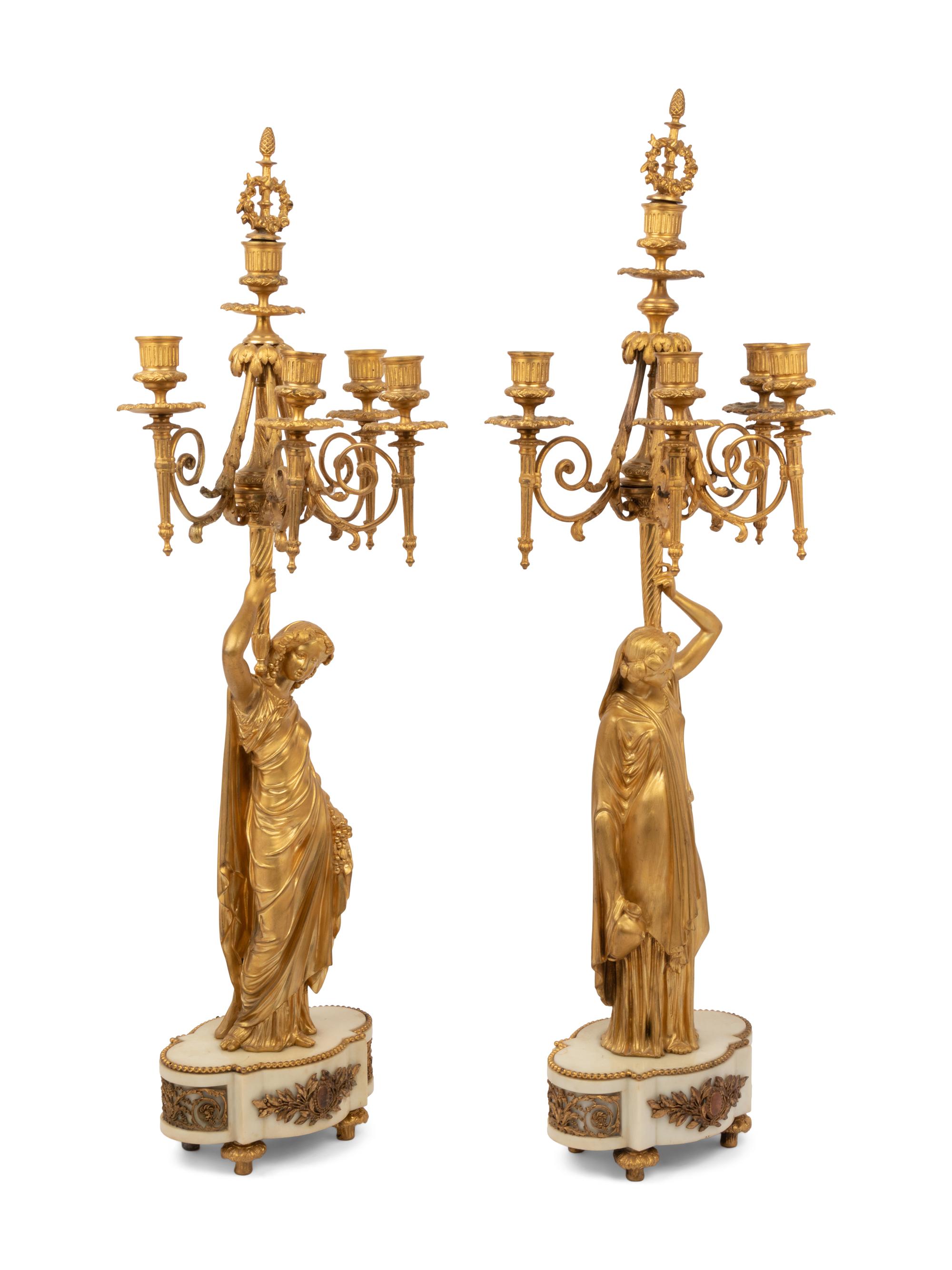 A Louis XVI Style Gilt Bronze and Marble Figural Clock Garniture