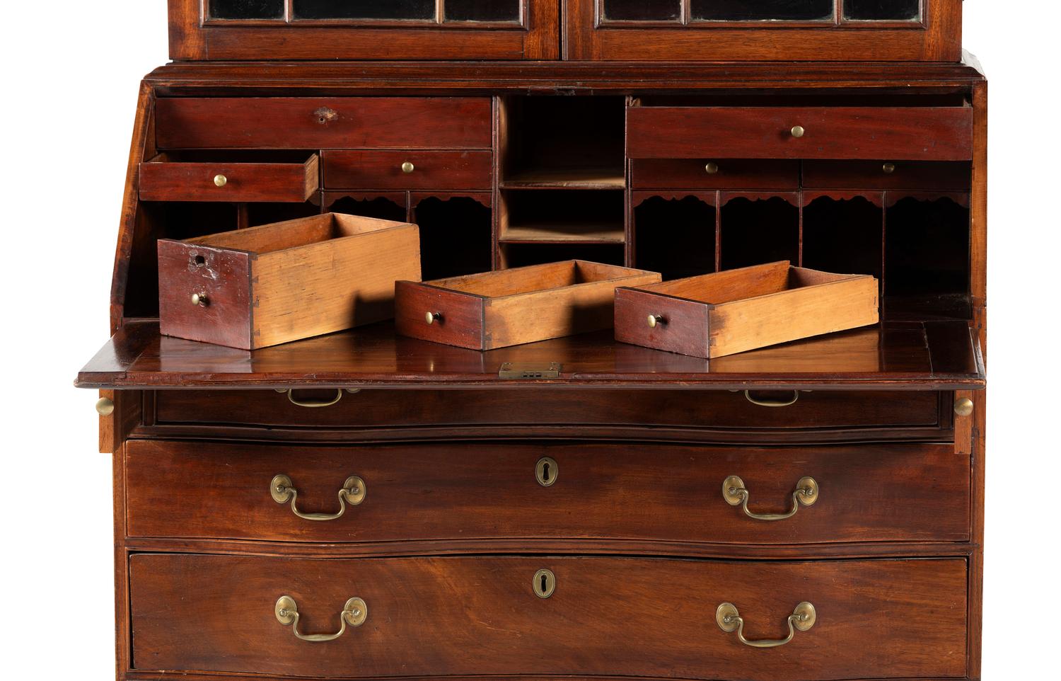 A Chippendale Mahogany and Cherrywood Serpentine Claw-and-Ball Foot Desk-and-Bookcase