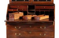 A Chippendale Mahogany and Cherrywood Serpentine Claw-and-Ball Foot Desk-and-Bookcase