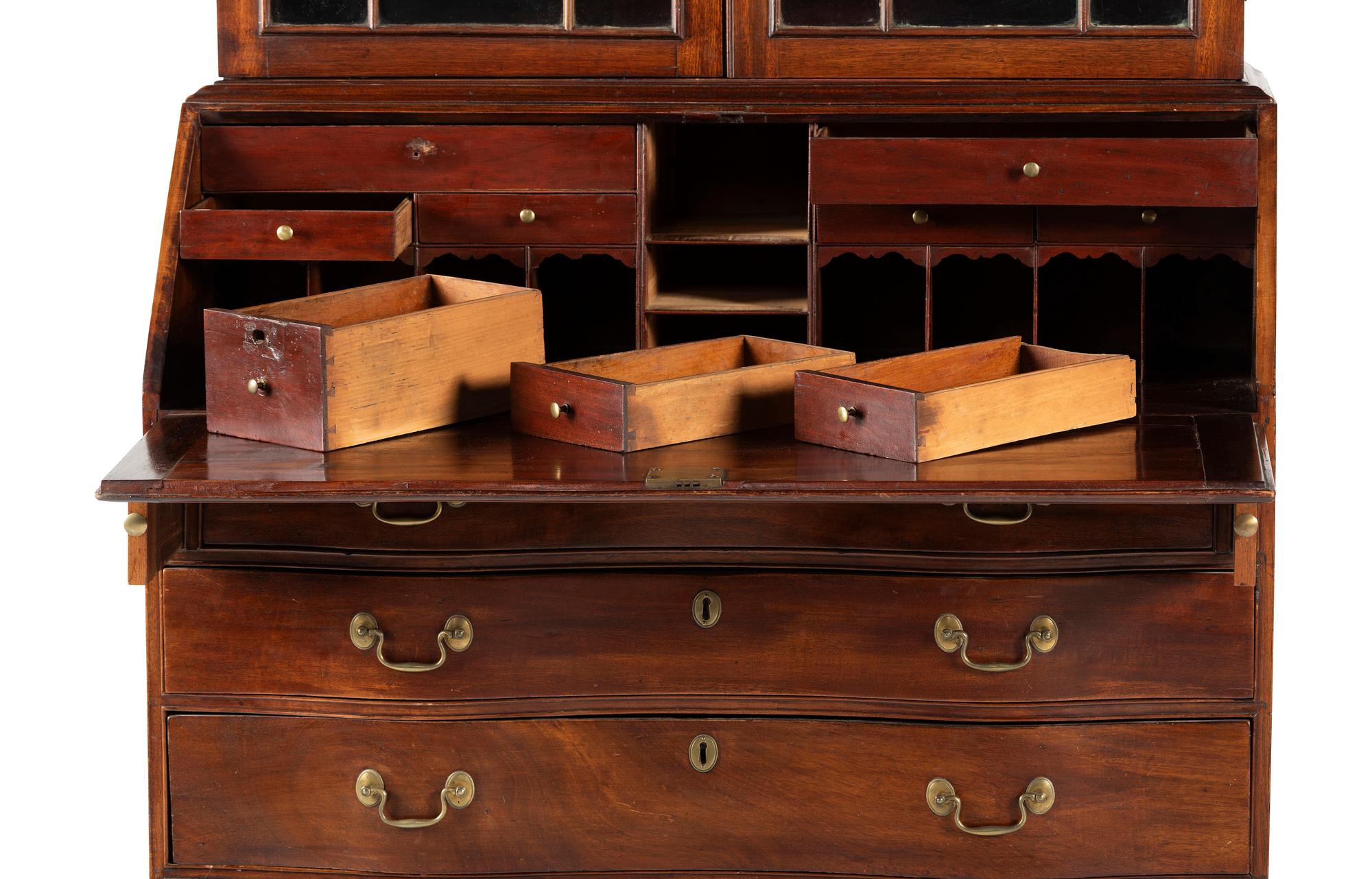 A Chippendale Mahogany and Cherrywood Serpentine Claw-and-Ball Foot Desk-and-Bookcase