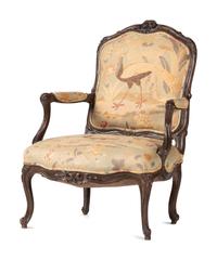 A Louis XV Carved Walnut Upholstered Fauteuil