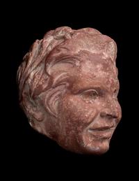 A Roman Rosso Antico Head of a Young Satyr