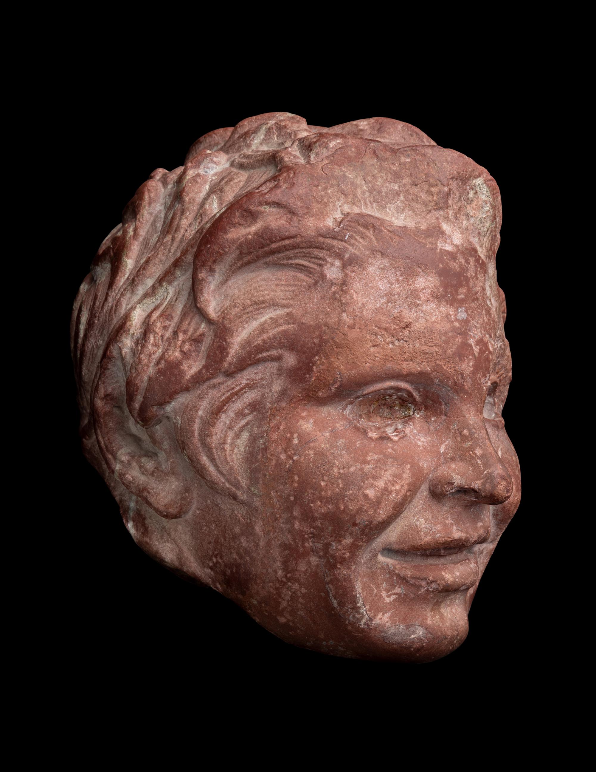 A Roman Rosso Antico Head of a Young Satyr