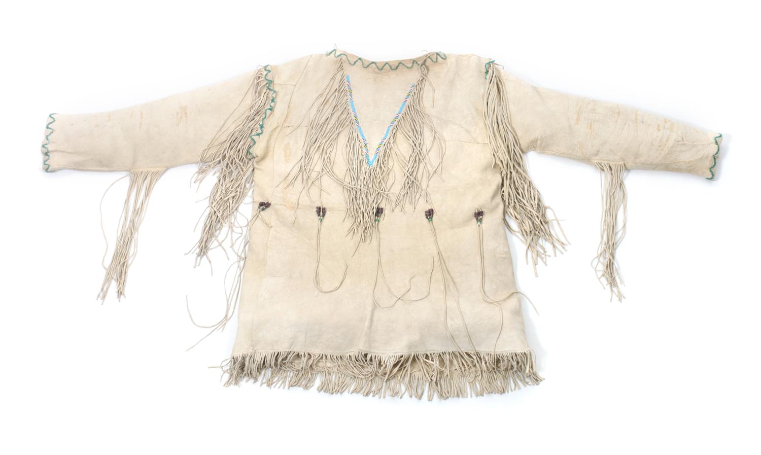 A Southern Cheyenne Hide Shirt Length 29 inches. — CIRCA 1930
