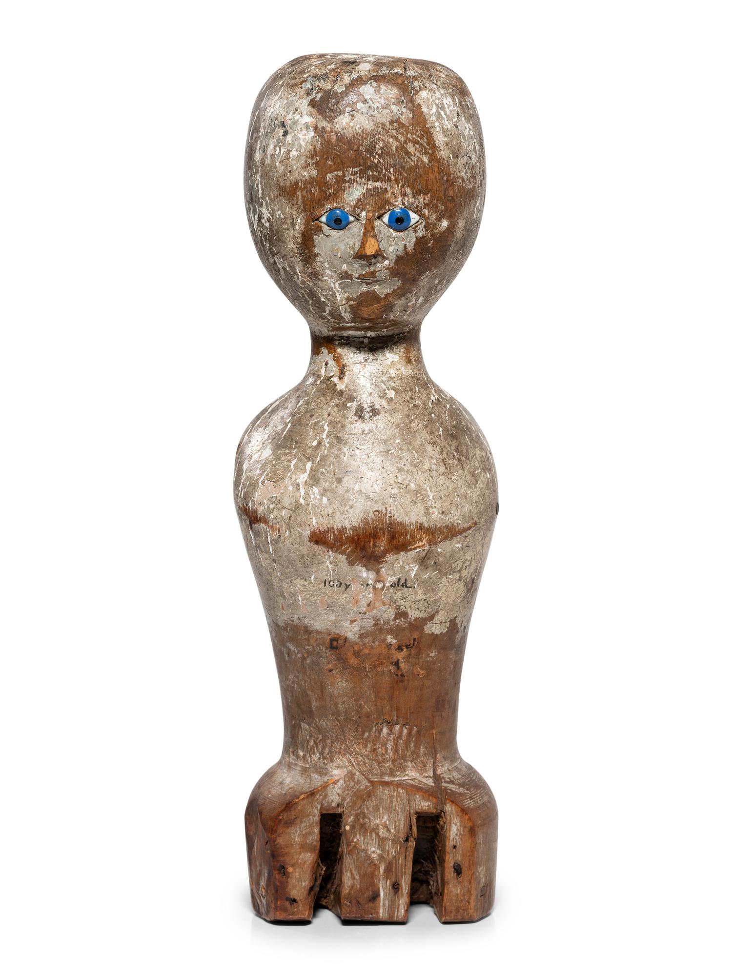 A Folk Art Carved, Painted and Glass Inset Wood Doll "Bed Post" Figure