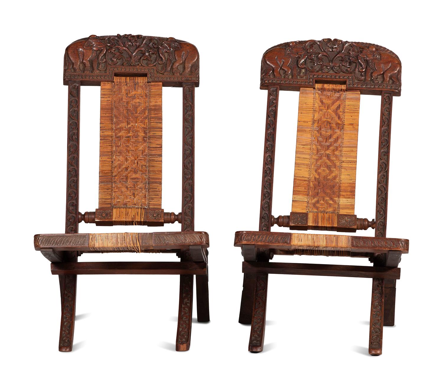 A Pair of Anglo-Indian Elephant-Carved Teak Cane Upholstered Folding Campaign Chairs
