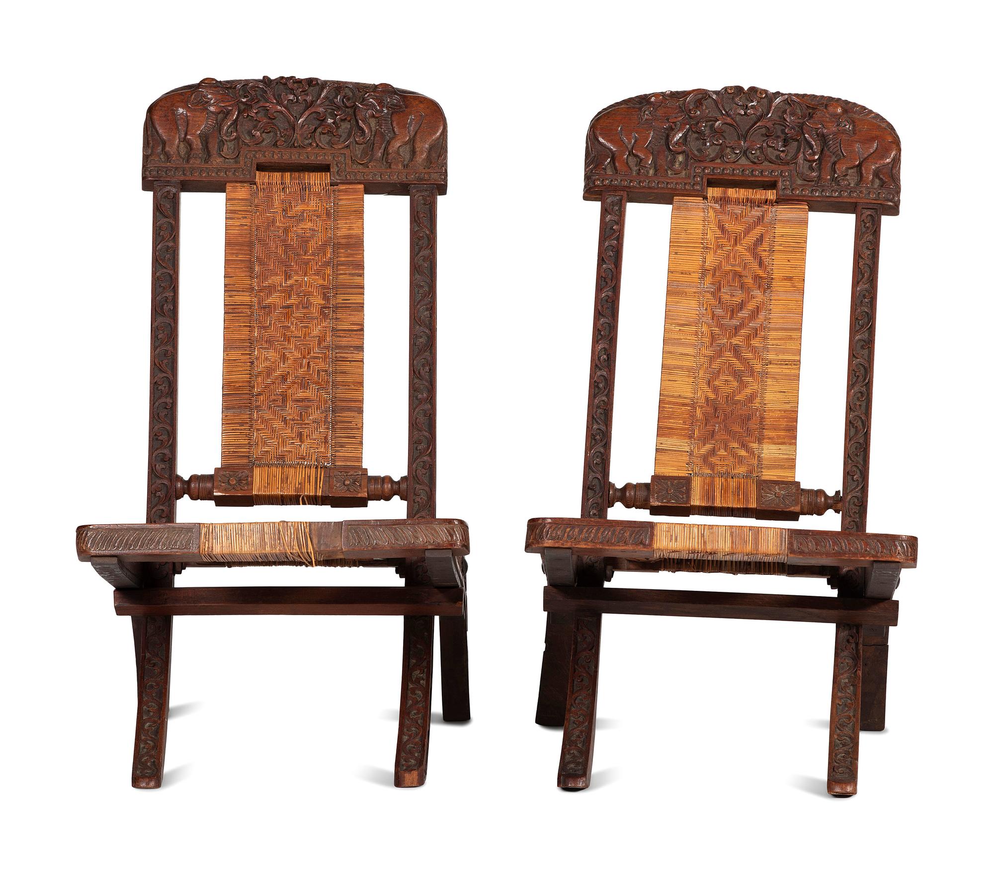 A Pair of Anglo-Indian Elephant-Carved Teak Cane Upholstered Folding Campaign Chairs