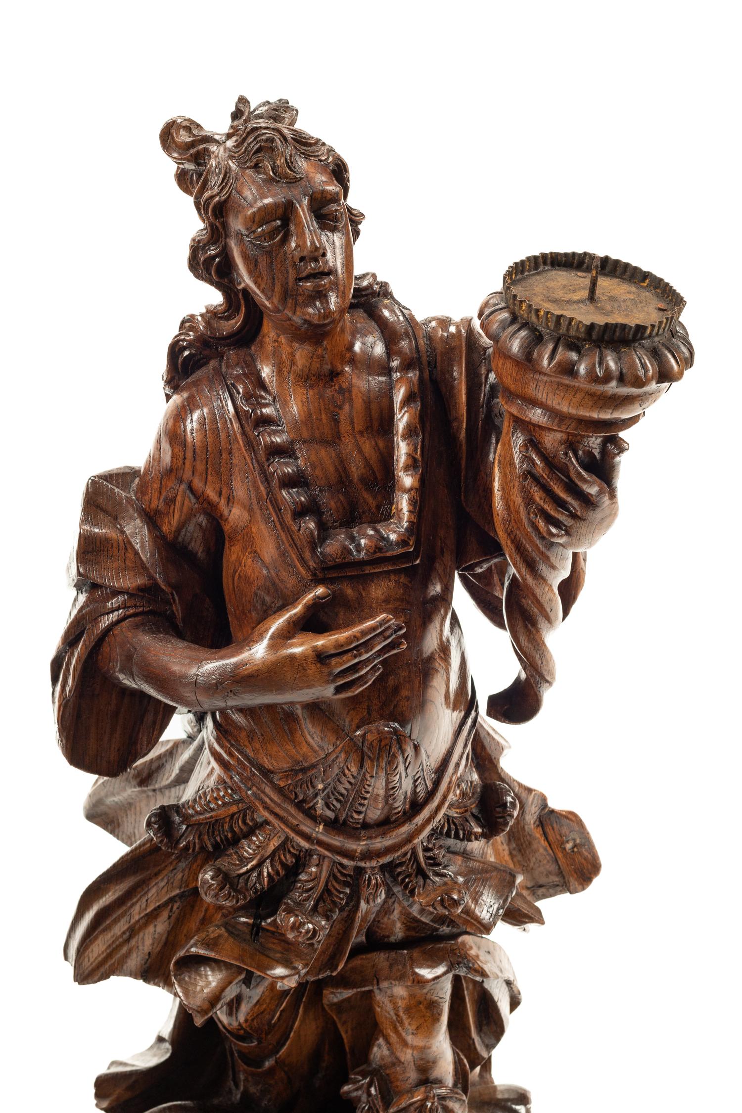 A Pair of Continental Carved Wood Figural Prickets