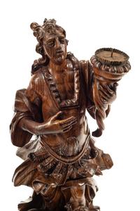A Pair of Continental Carved Wood Figural Prickets