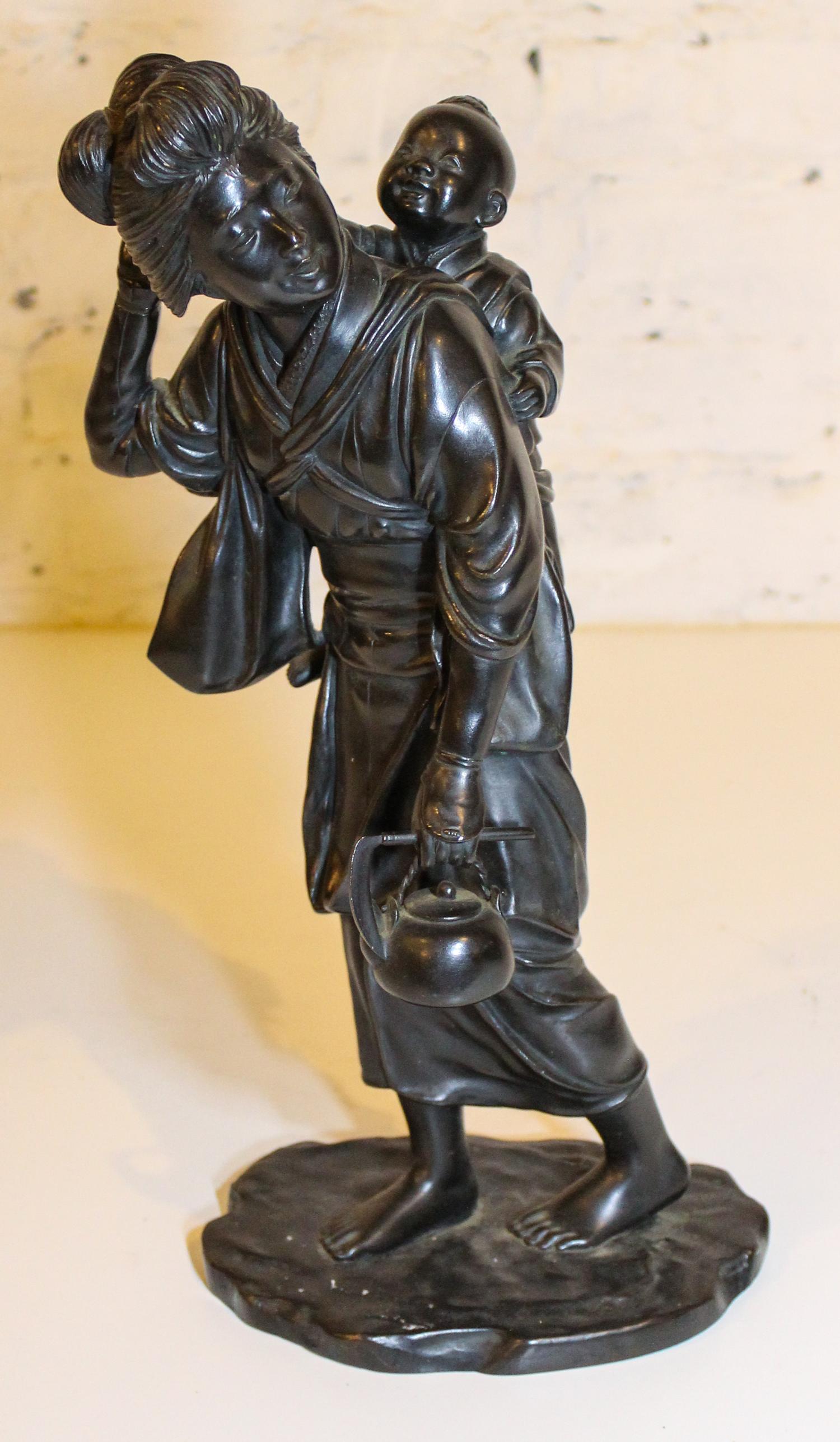 A Japanese Bronze Figural Group. Height 15 1/4 inches.