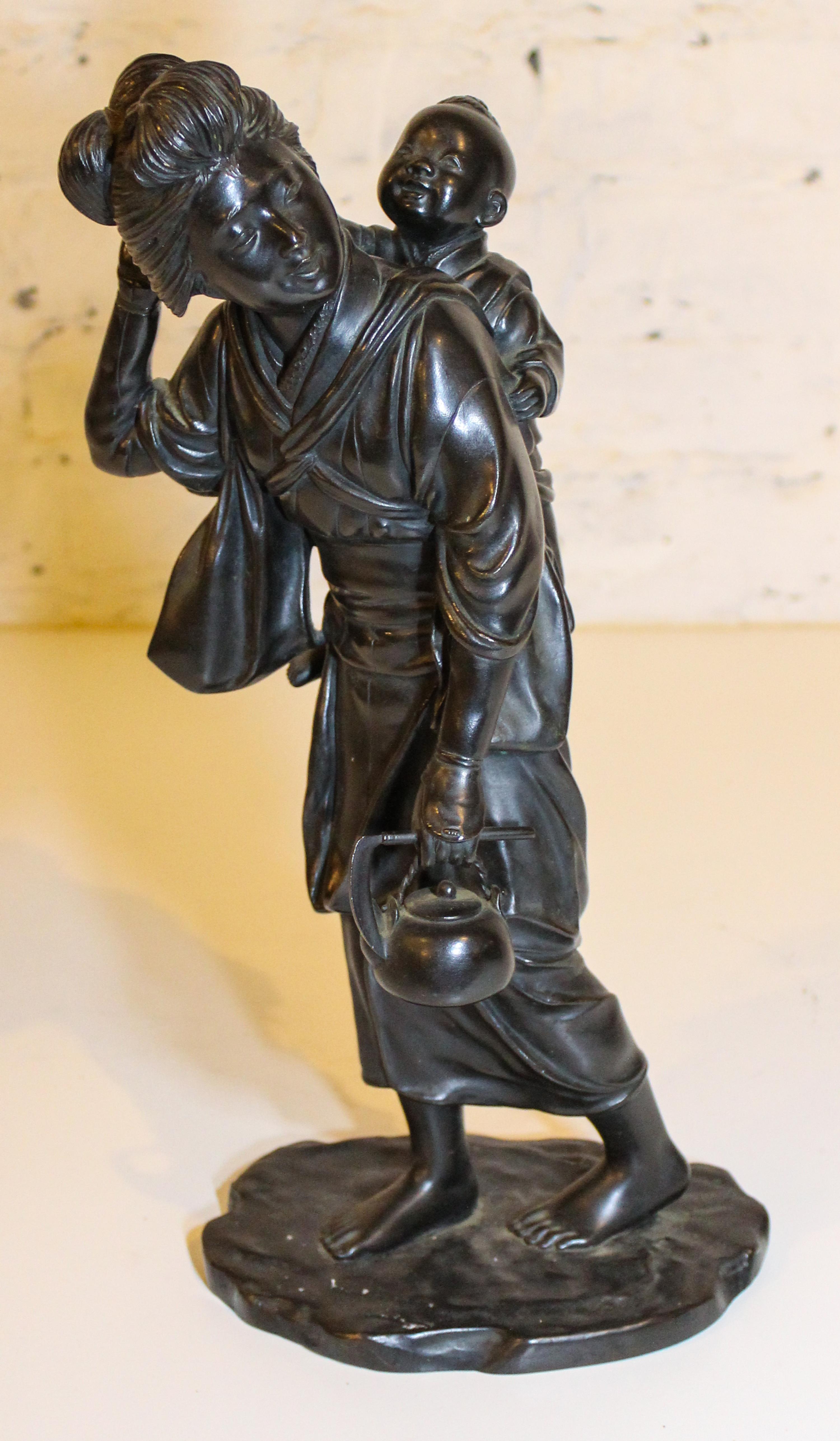 A Japanese Bronze Figural Group. Height 15 1/4 inches.