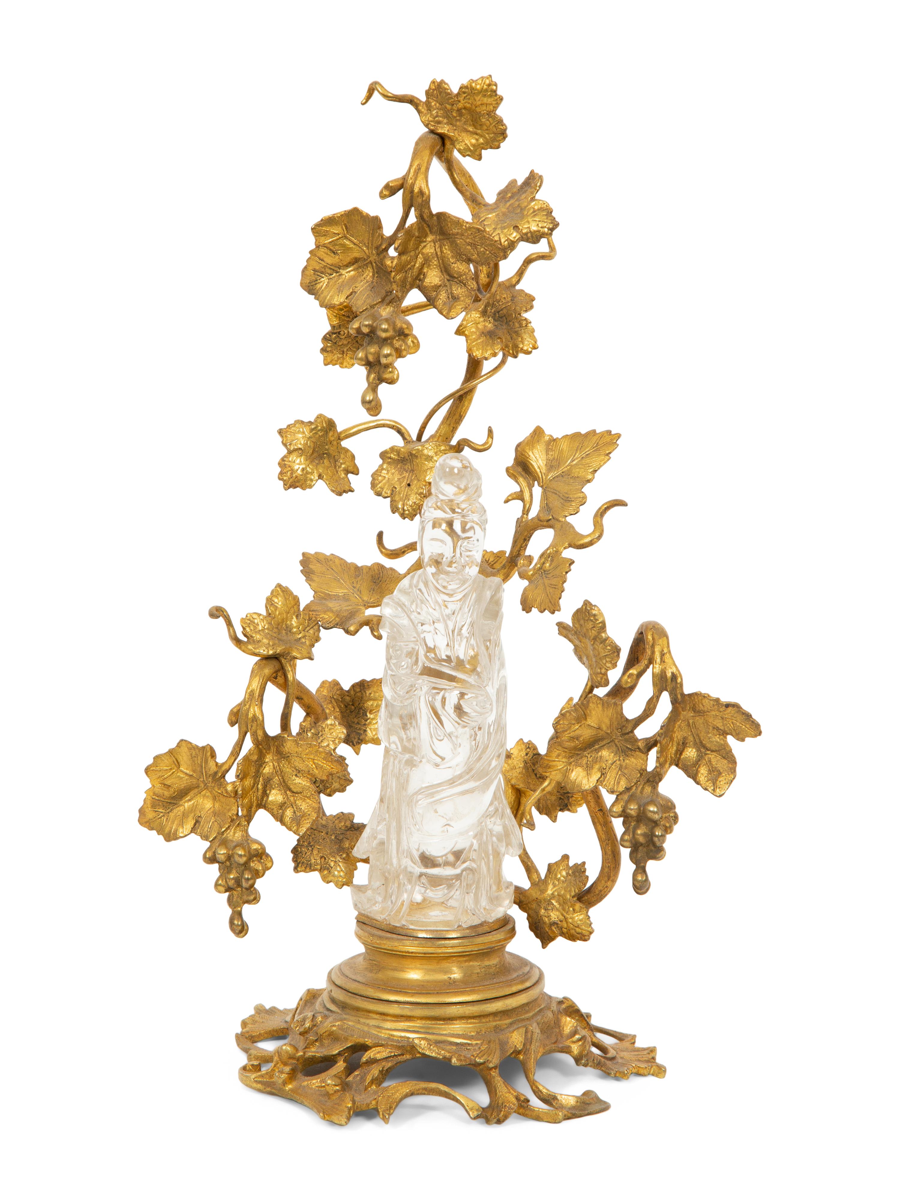 A Carved Rock Crystal Figure of Guanyin on a Grapevine Decorated Gilt Bronze Stand