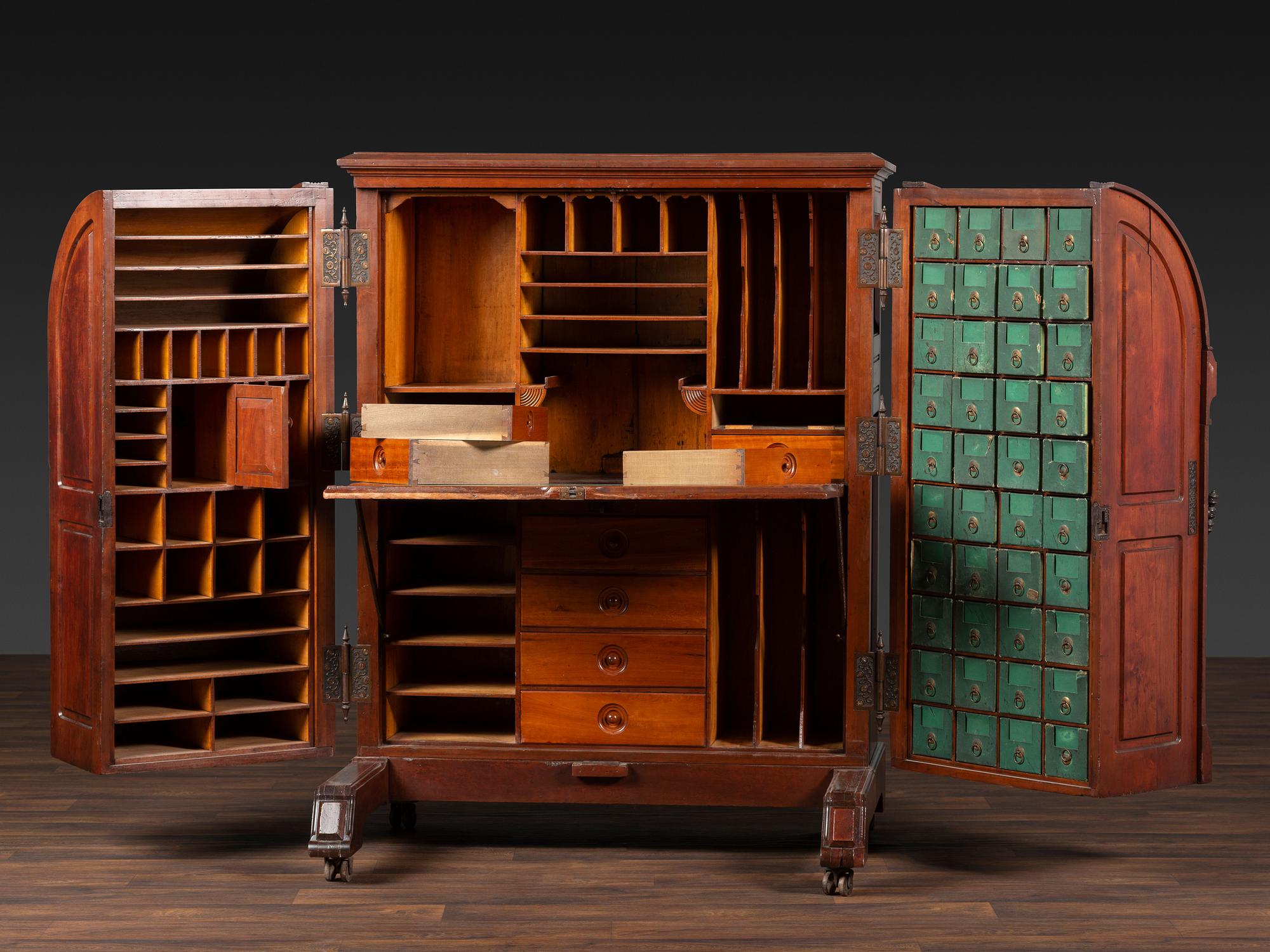 A Carved Walnut Wooton Secretary Desk