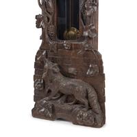 A Swiss Black Forest Carved Tall Case Clock