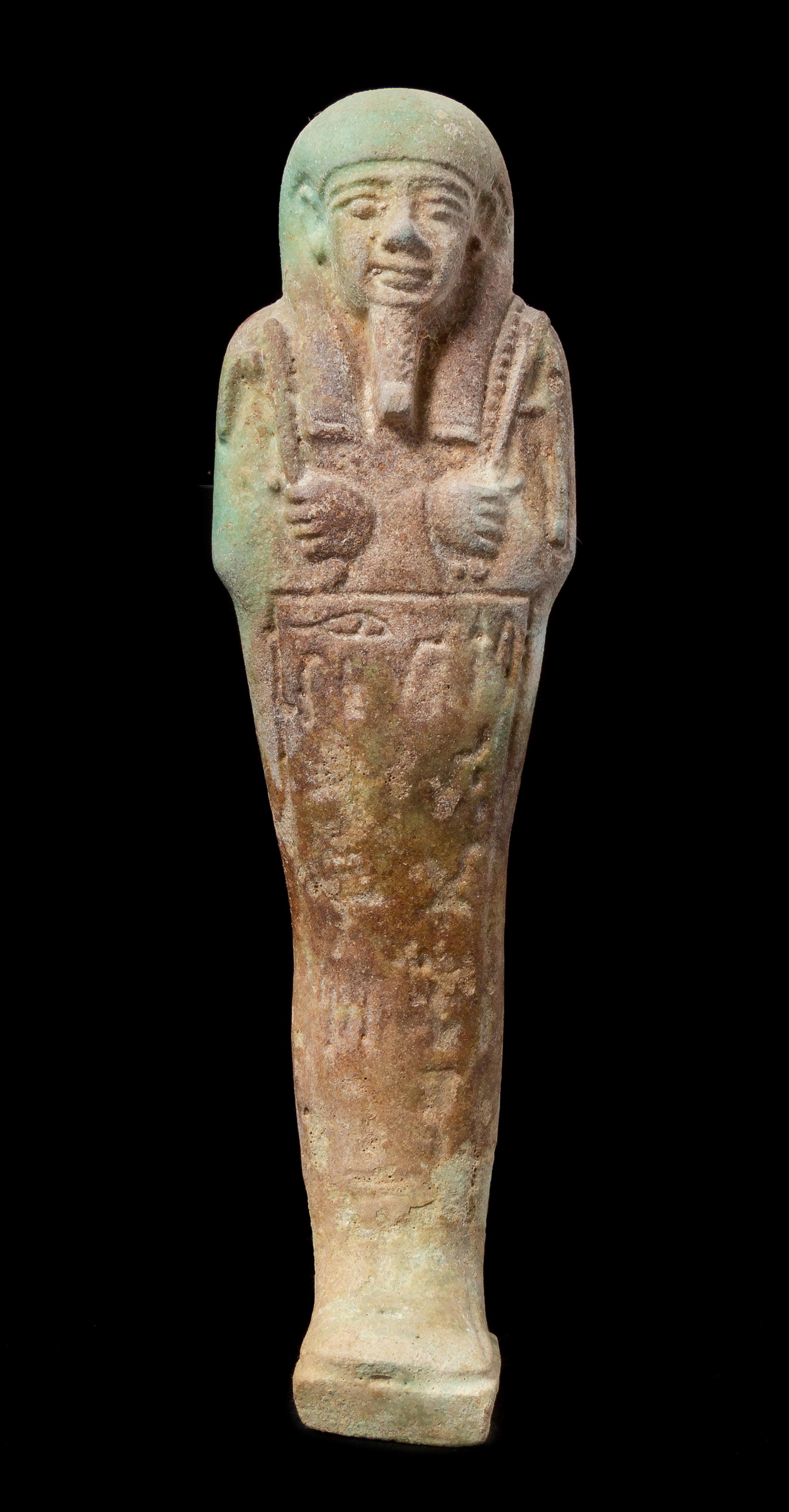An Egyptian Faience Shabti Height 7 1/2 inches. — LATE PERIOD, DYNASTY 26, 664-525 B.C.E.
