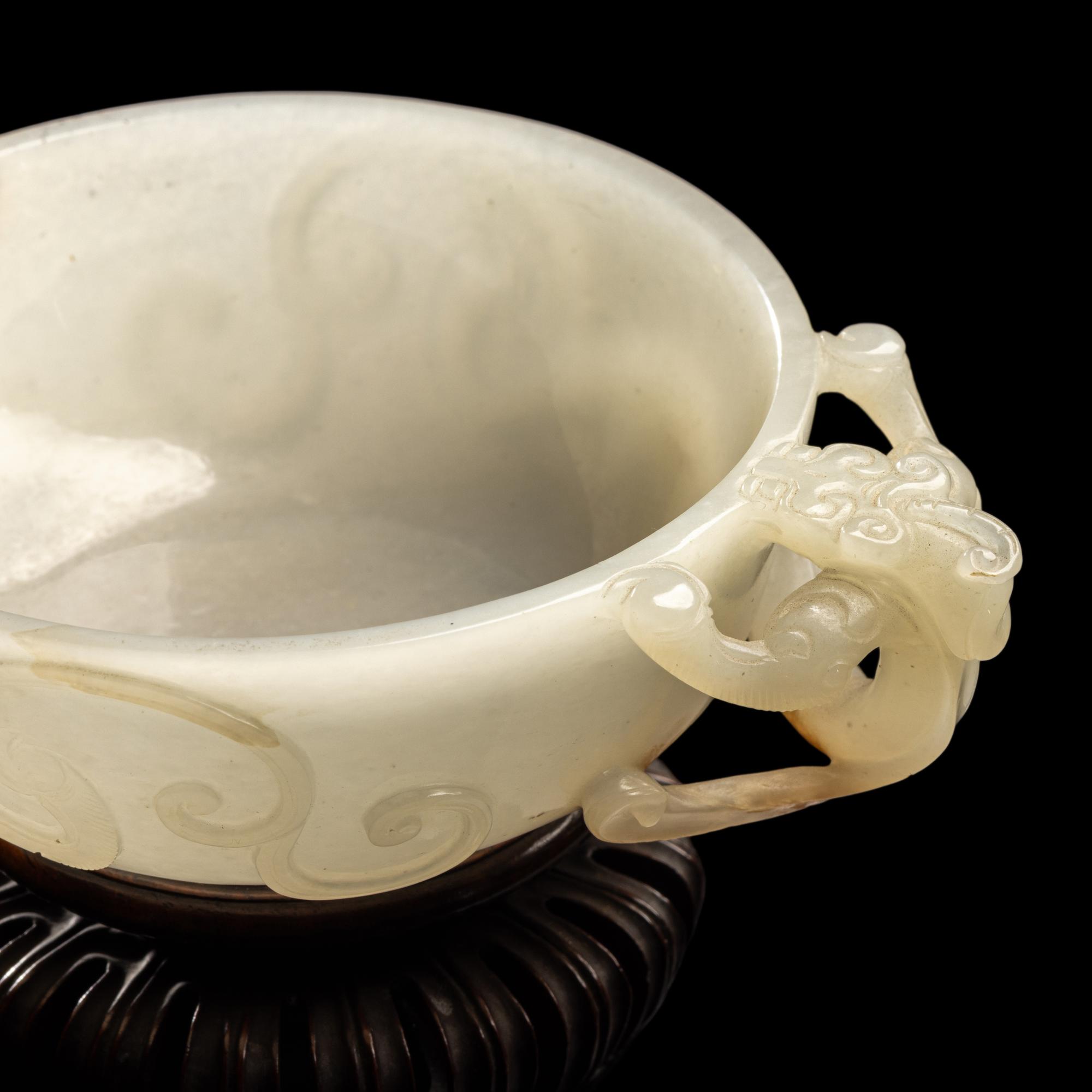 A Chinese Carved White Jade 'Chilong' Handled Cup, 19th/Early 20th Century 晚清/民國 白玉螭龍雙耳杯