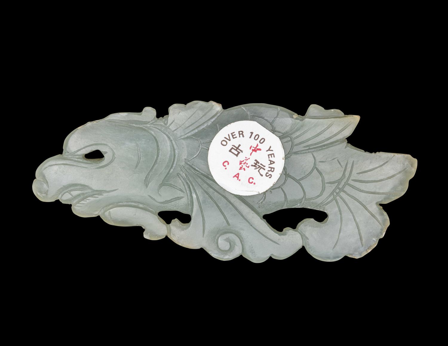 A Chinese Celadon Jade Carving of a Dragon-Carp