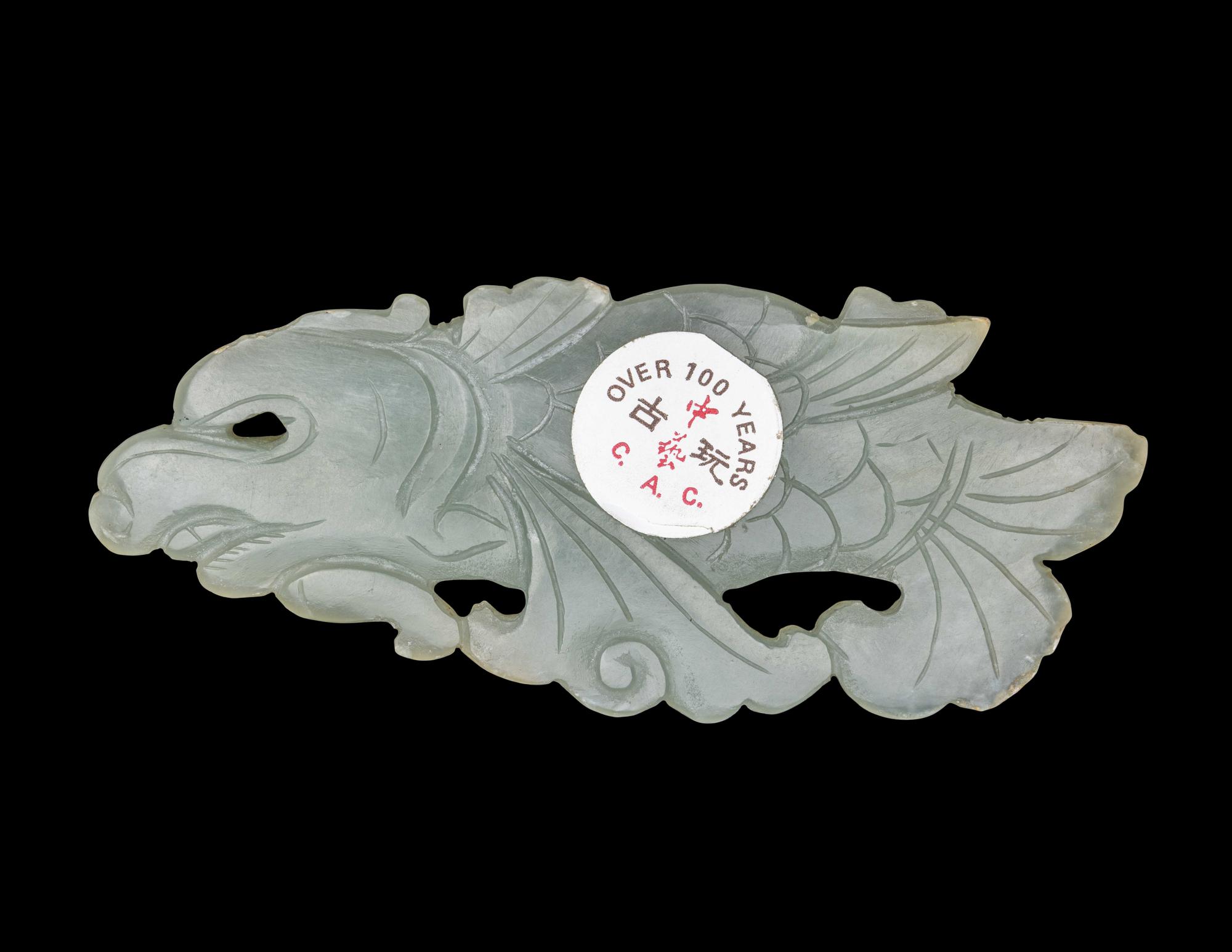 A Chinese Celadon Jade Carving of a Dragon-Carp