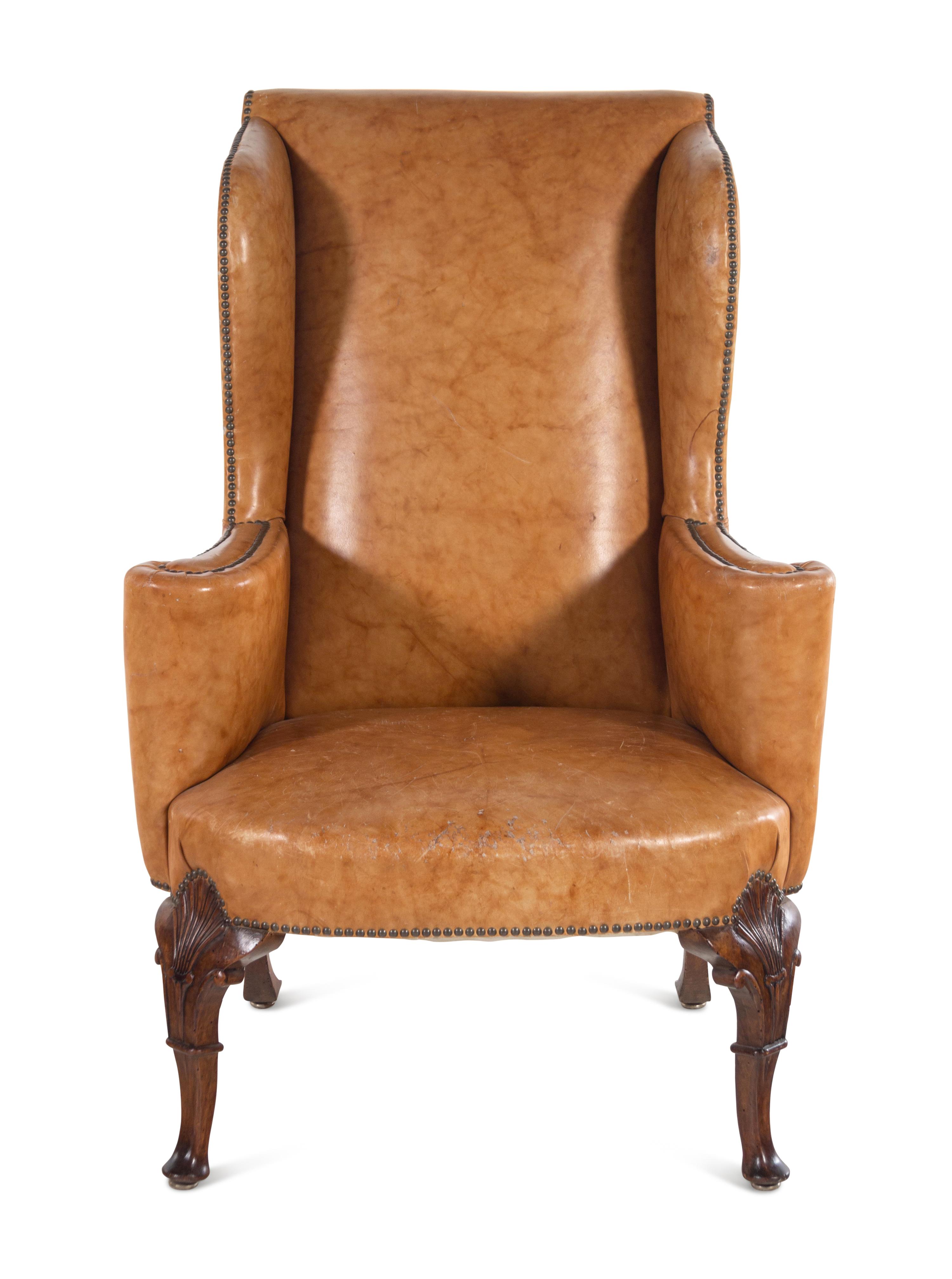 A Georgian Style Faux Leather Upholstered Walnut Wing Chair