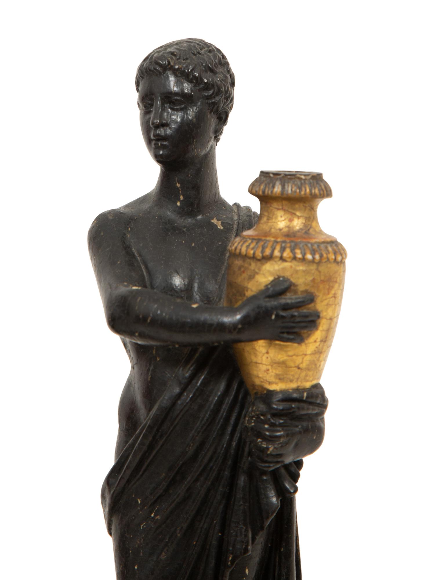 A Pair of Continental Carved, Parcel Ebonized and Gilt Wood Neoclassical Figures