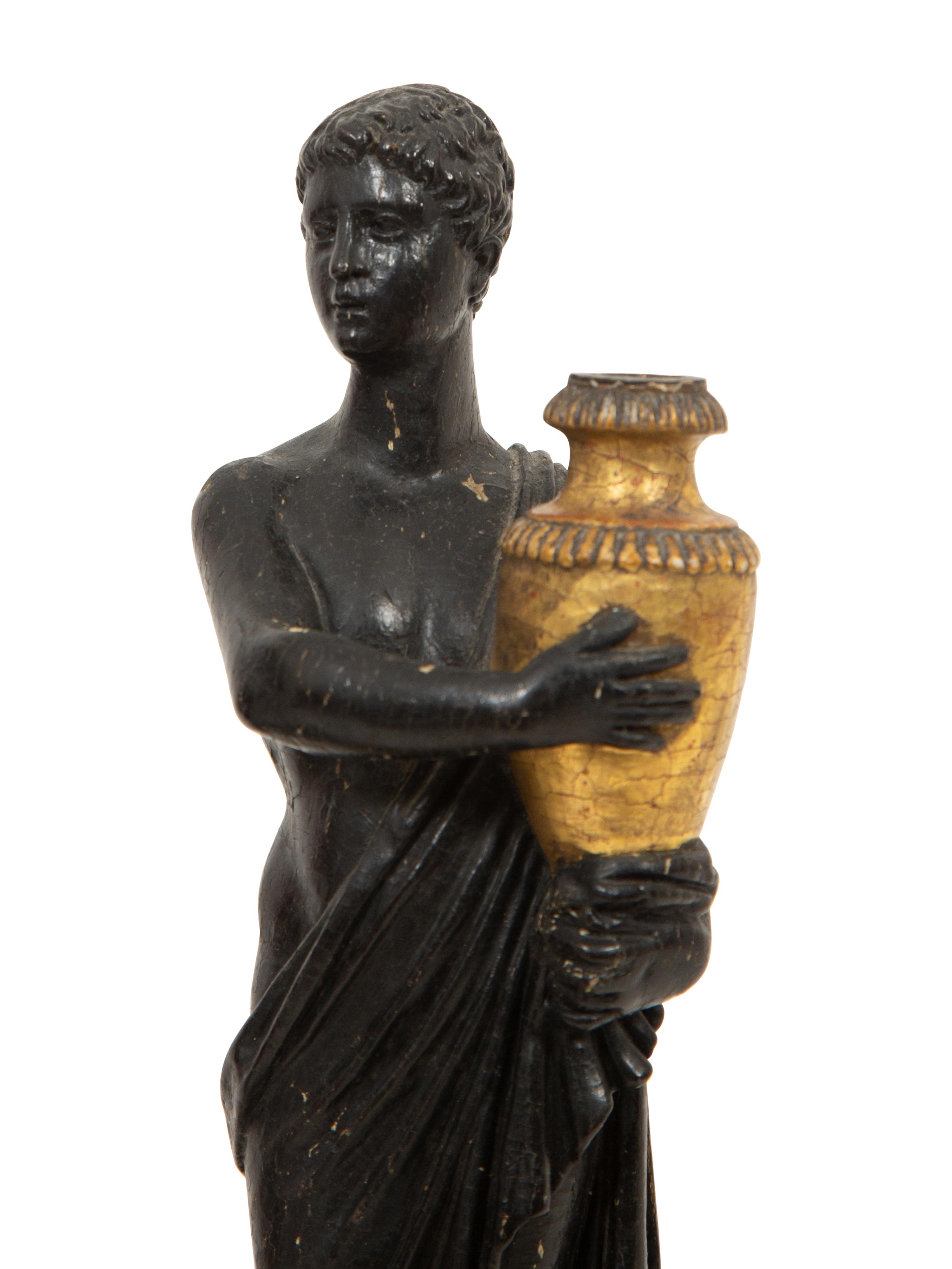 A Pair of Continental Carved, Parcel Ebonized and Gilt Wood Neoclassical Figures