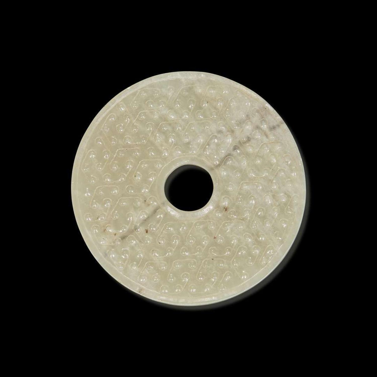A Chinese greyish white jade archaistic bi disk 灰白玉璧