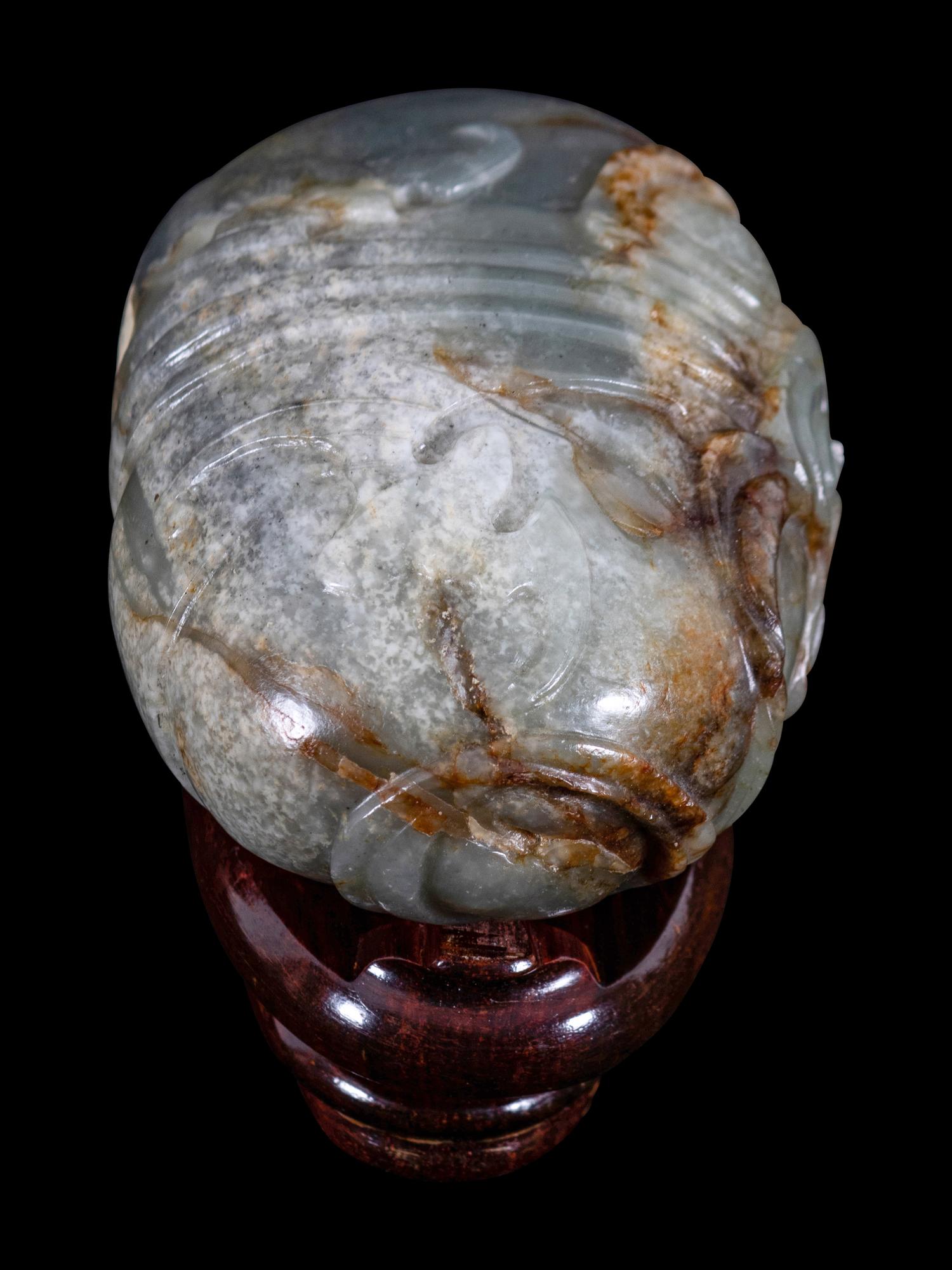 A Grey and Russet Jade Purse-Form Paperweight