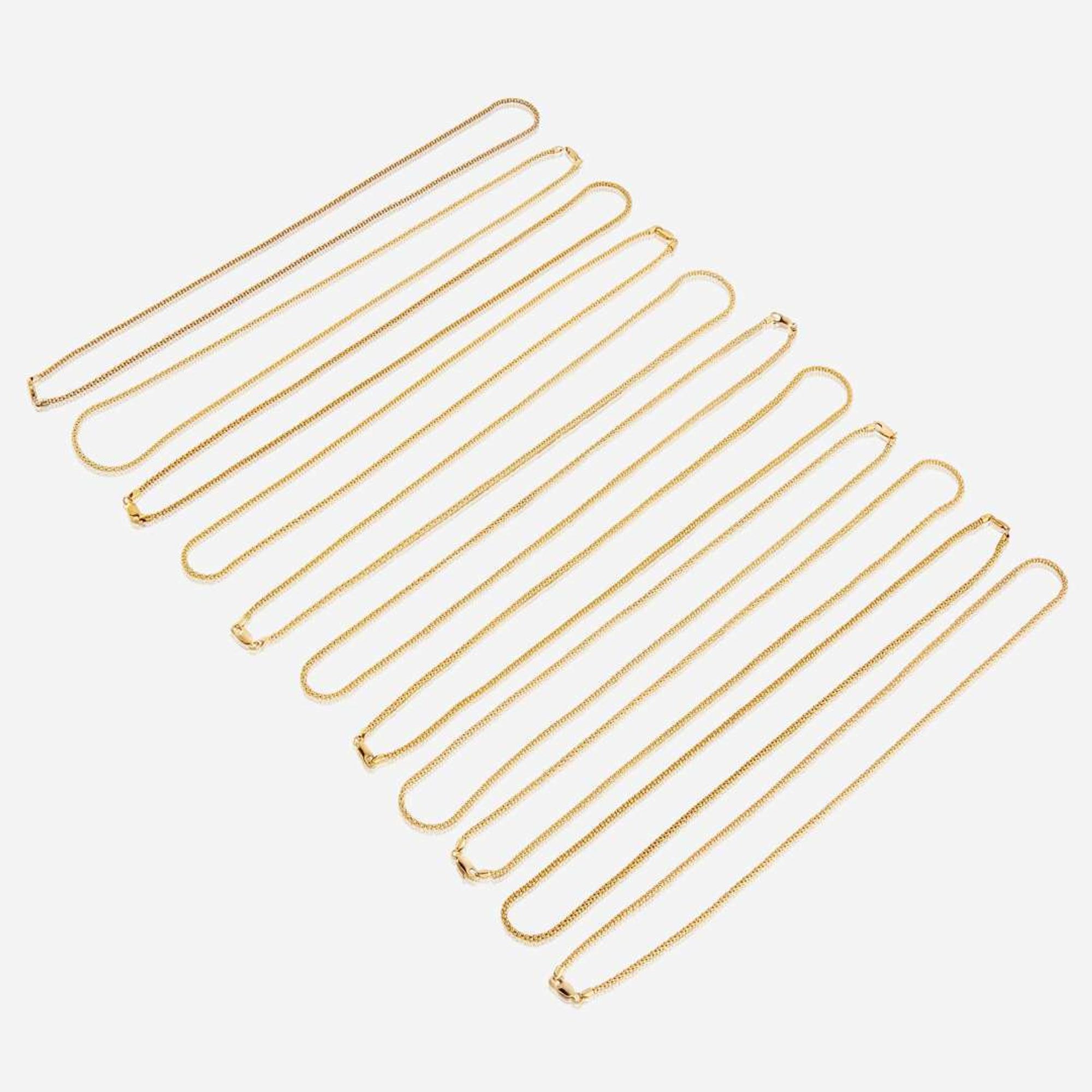 A collection of eleven fourteen karat gold necklaces