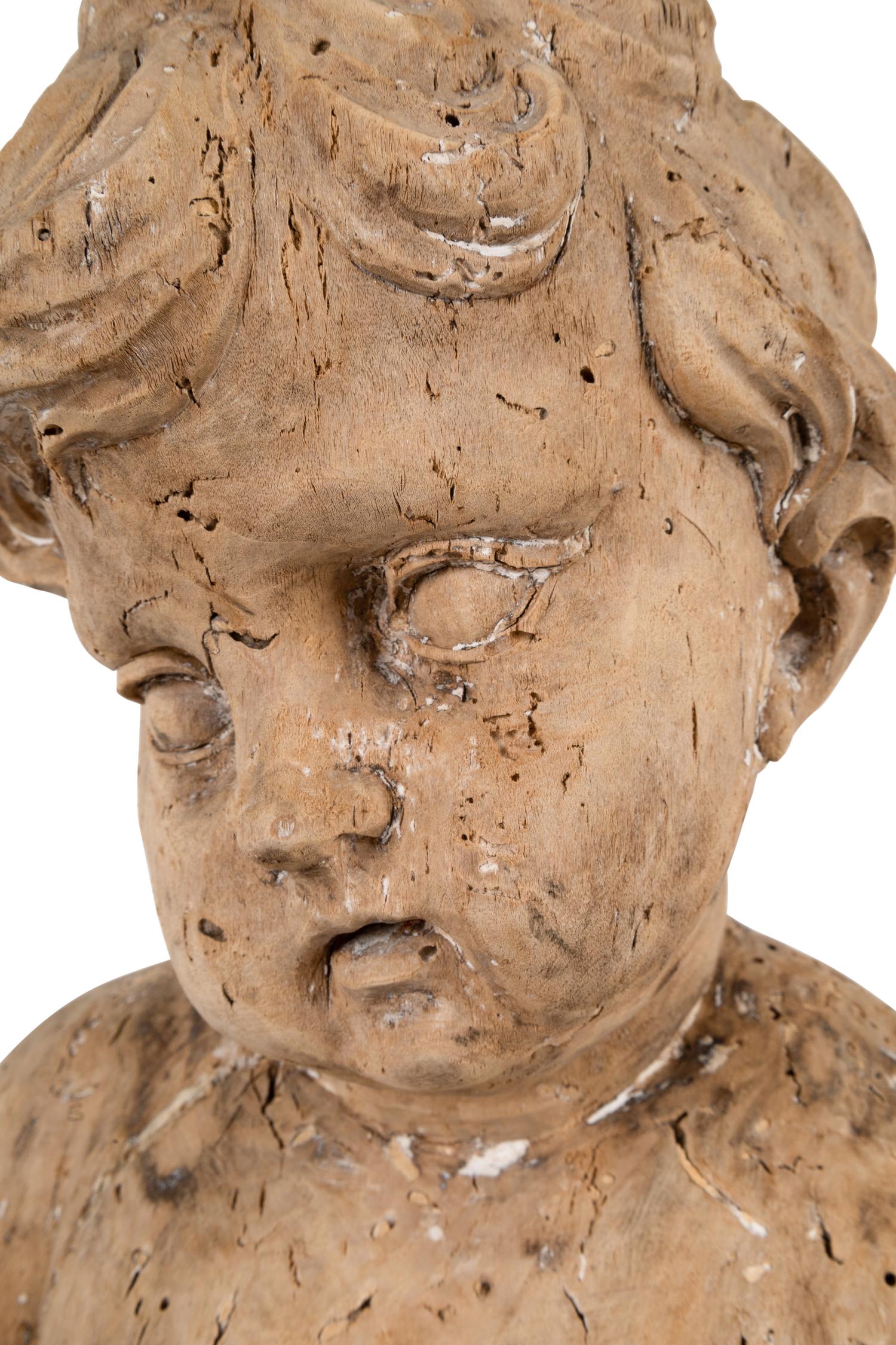 A Continental Carved Wood Putto