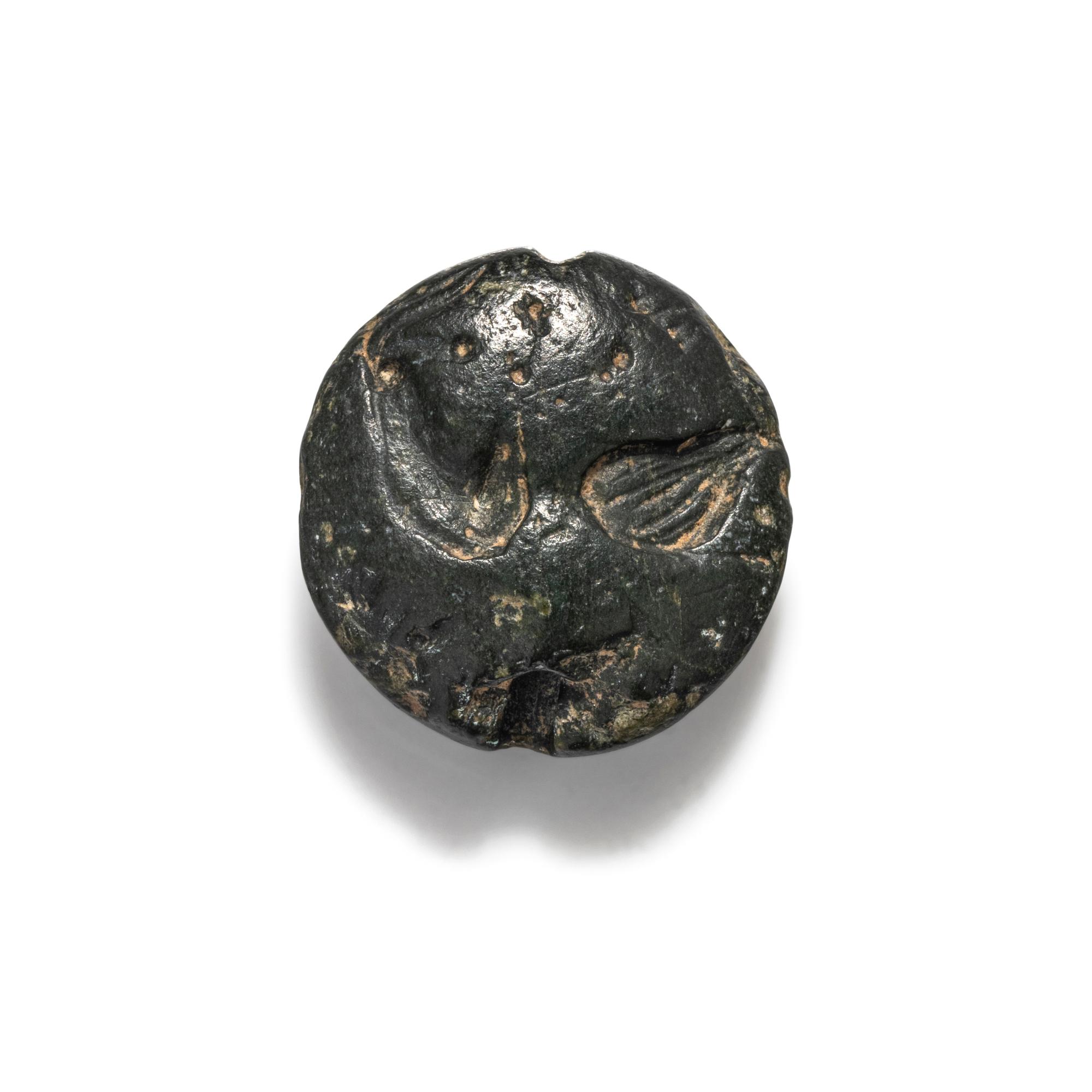 A Minoan Black Steatite Lentoid with a Bull Head and Leaf.