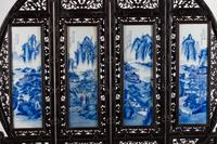 A Chinese Blue and White Porcelain-Mounted Carved Hardwood Four Panel Floor Screen