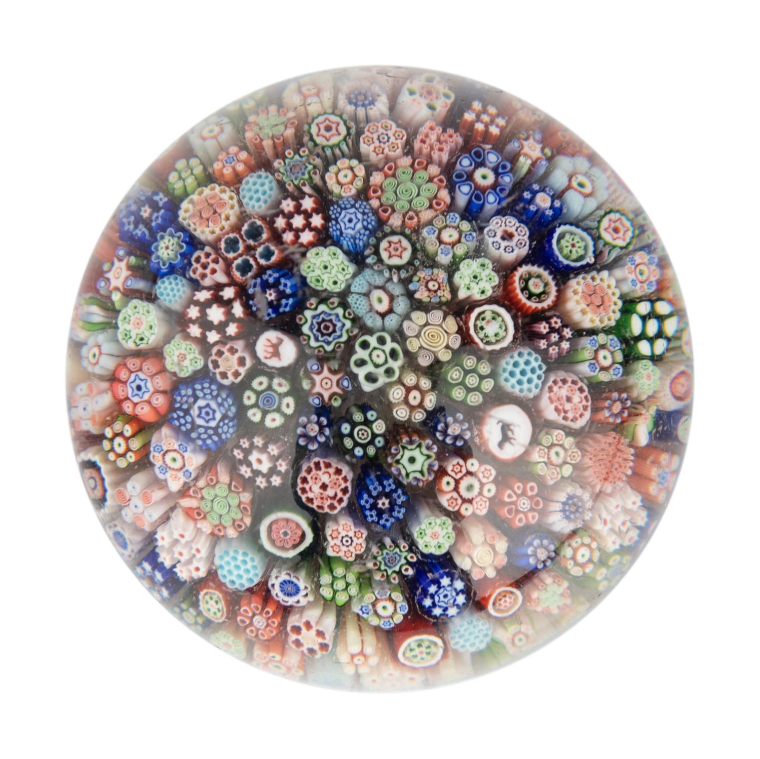 A Miniature Baccarat Close Packed Millefiori and Silhouette Glass Paperweight
