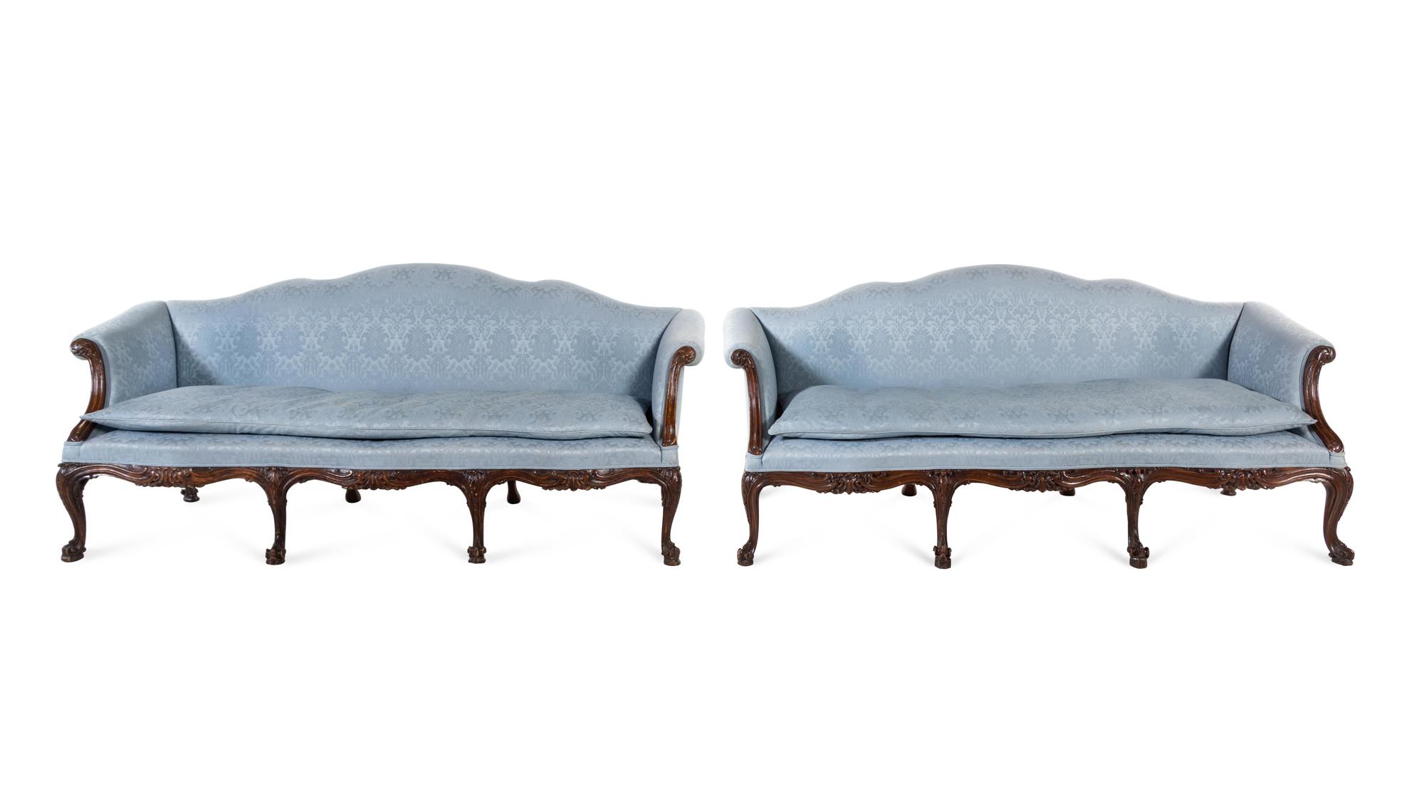 A Pair of George III Carved Oak Sofas