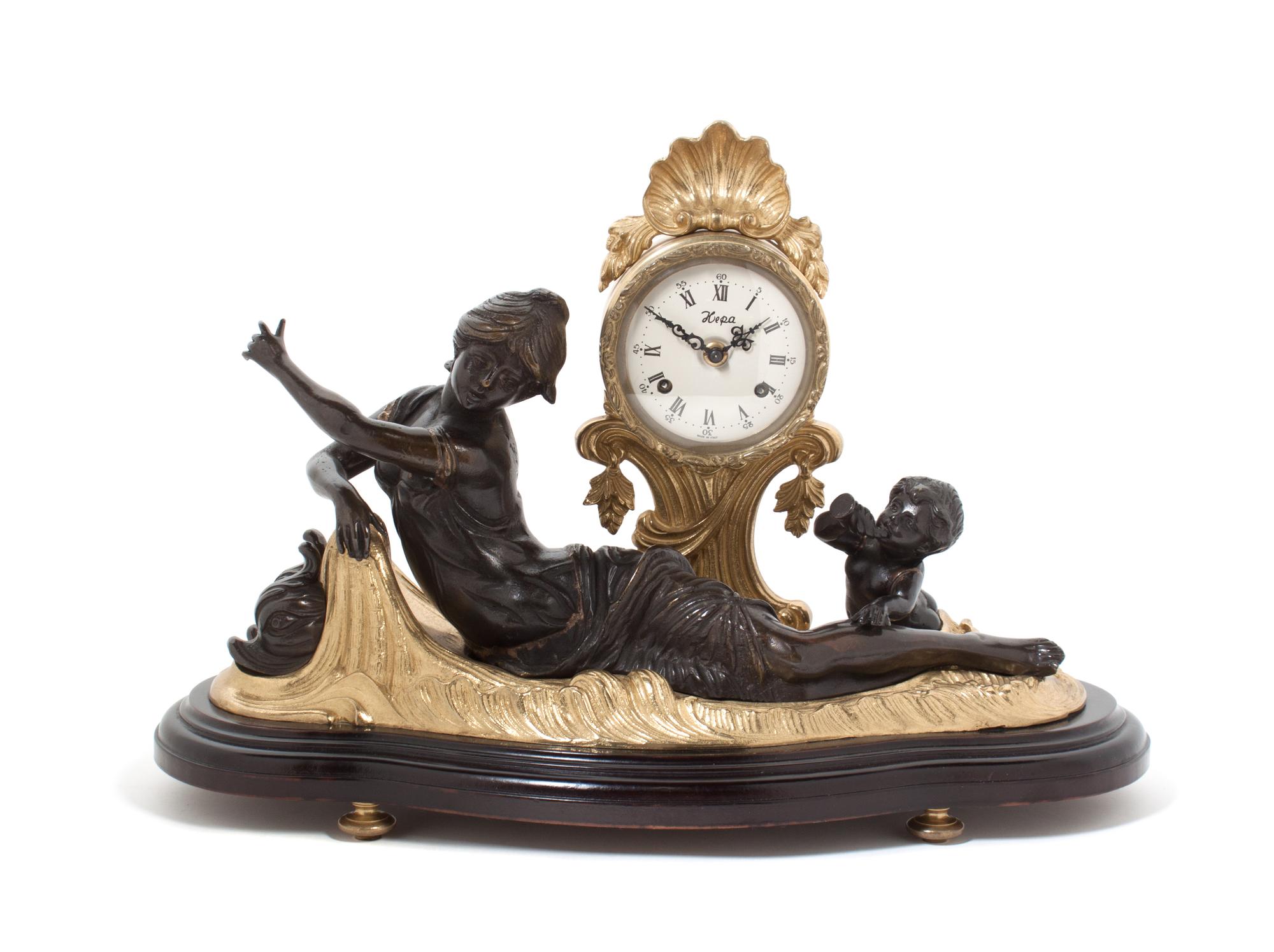 A Contemporary Gilt and Patinated Bronze Figural Three-Piece Clock Garniture, Kepa Width of clock 22 inches. — SECOND HALF 20TH CENTURY