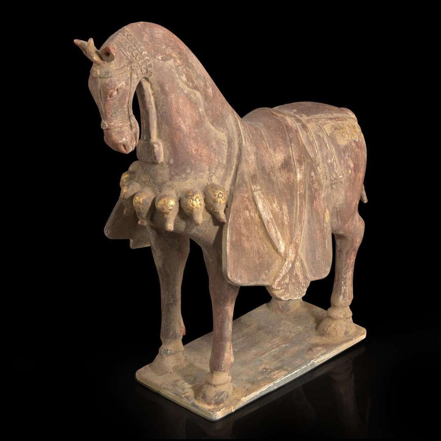 A Chinese painted and parcel-gilt pottery figure of a caparisoned horse 彩绘漆金陶马 Northern Wei dynasty ??