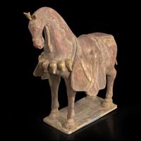 A Chinese painted and parcel-gilt pottery figure of a caparisoned horse 彩绘漆金陶马 Northern Wei dynasty ??
