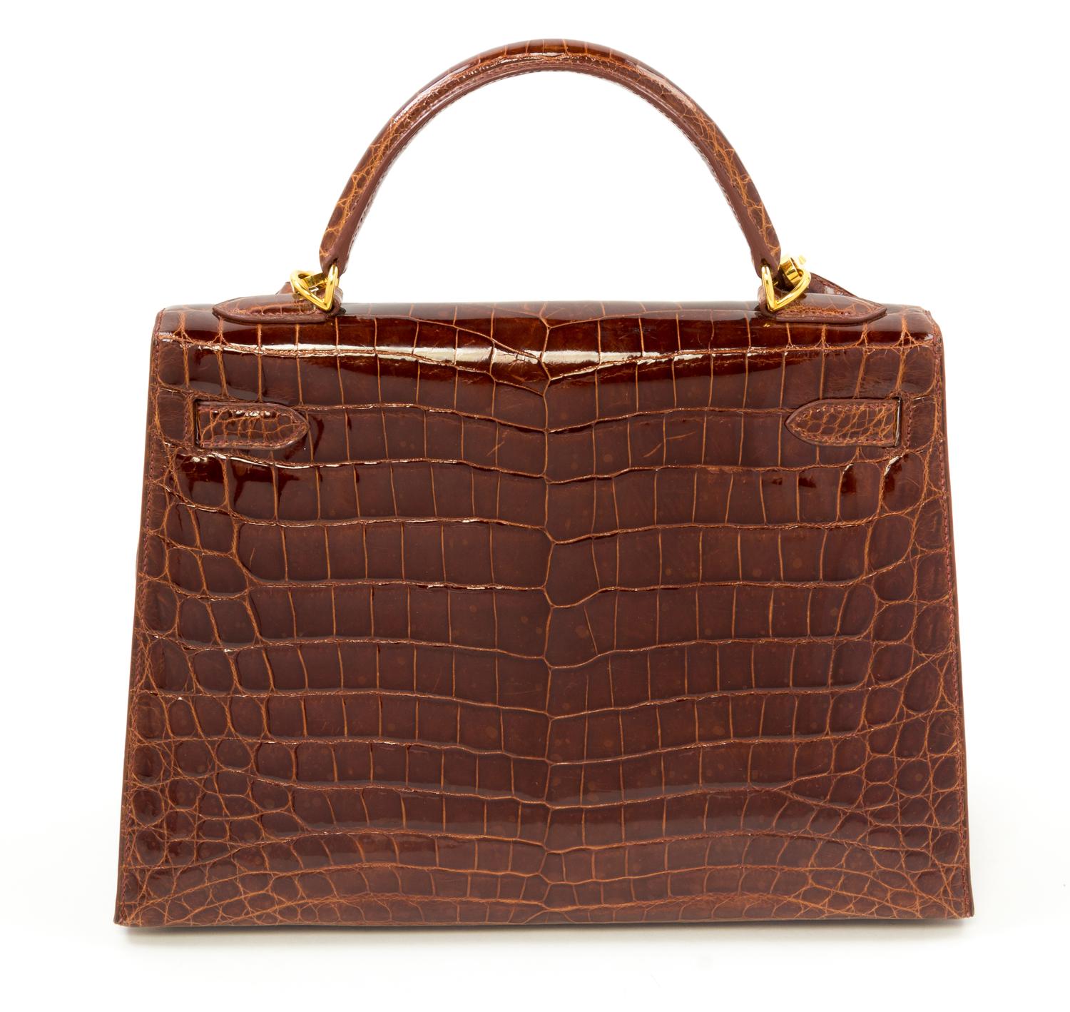 An Hermès Brown Niloticus Crocodile Sellier 32cm Kelly Handbag, 12.5" x 5" x 9.5"; Handle drop: 3.25".