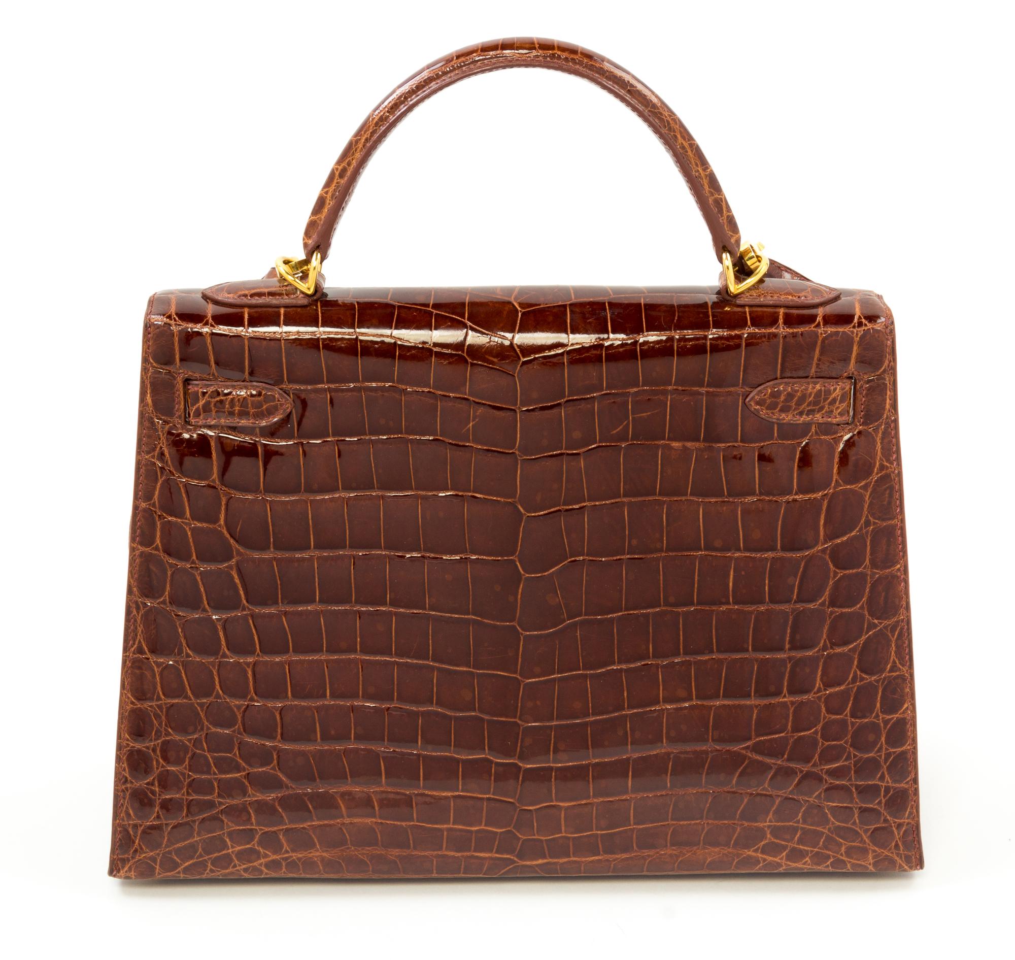 An Hermès Brown Niloticus Crocodile Sellier 32cm Kelly Handbag, 12.5" x 5" x 9.5"; Handle drop: 3.25".
