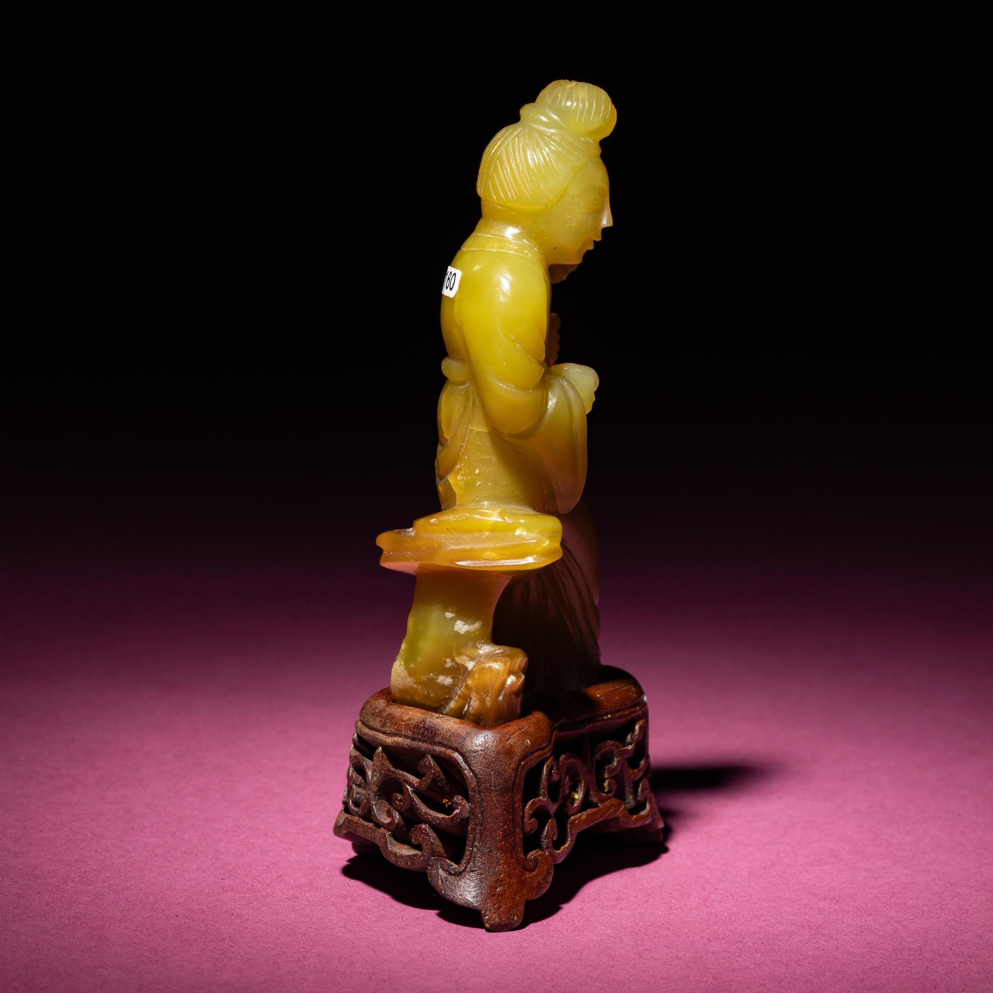 A Chinese Yellow Jade Seated Figure of a Lady, Late Qing Dynasty — 清晚期 黃玉持蓮仕女