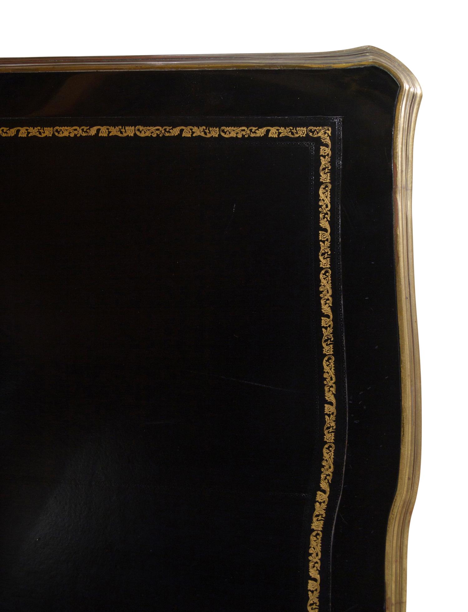 A Louis XV Style Gilt Metal Mounted Ebonized Bureau Plat