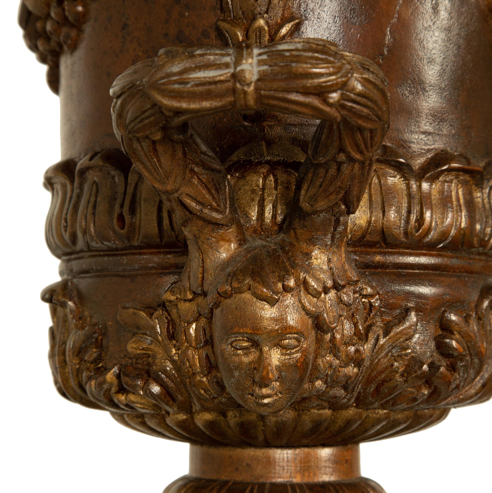 A Pair of George III Style Carved and Stained Wood Campana Urns on Pedestal Stands — 20TH CENTURY