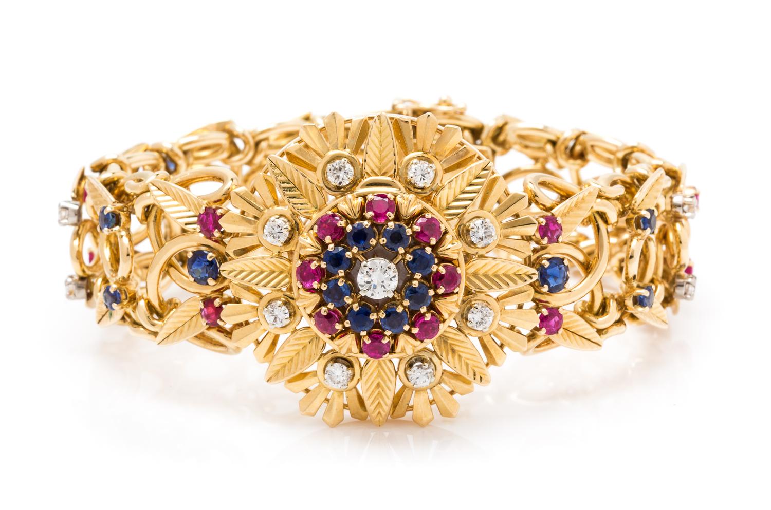 An 18 Karat Yellow Gold Diamond, Ruby and Sapphire Surprise Watch Bracelet, 60.30 dwts.