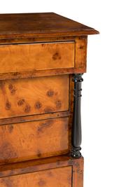 A Biedermeier Part-Ebonized Burlwood Commode