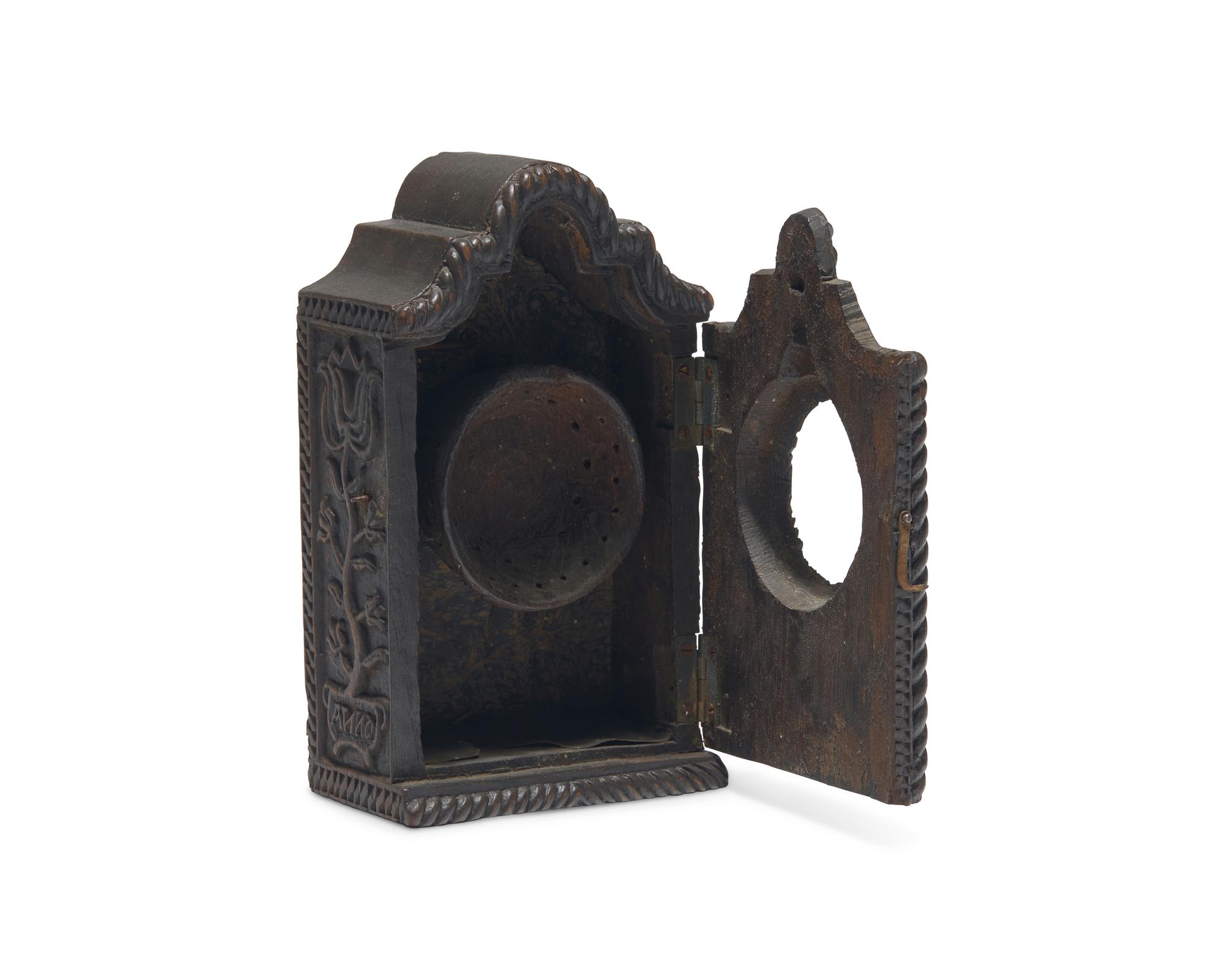 A Continental Carved Walnut Watch Hutch