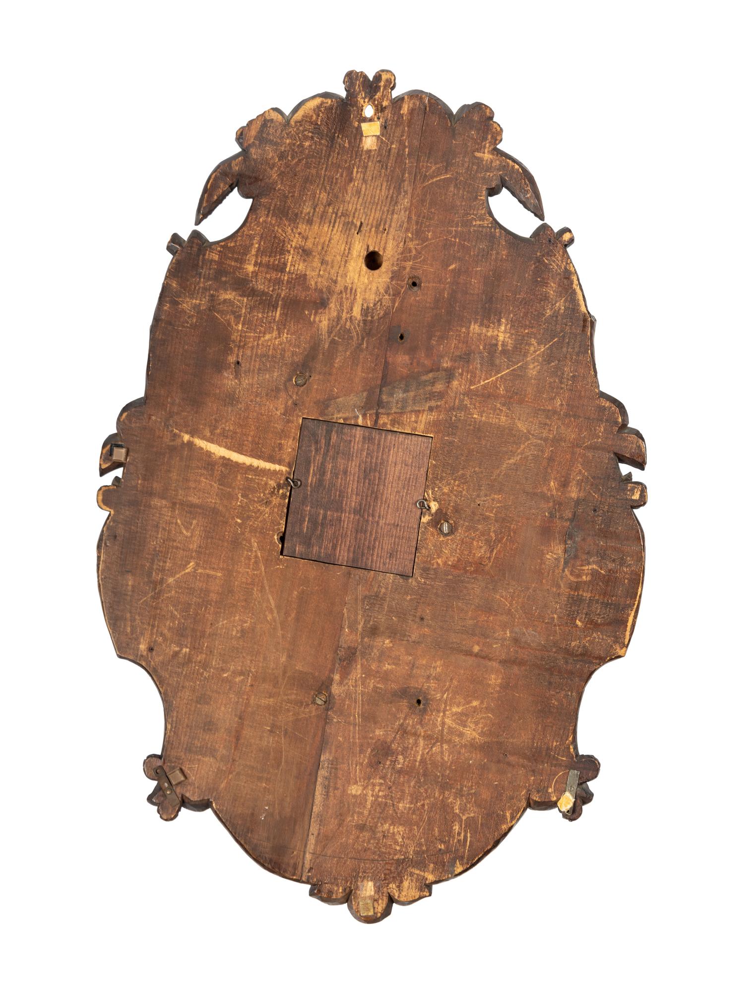 A Swiss Black Forest Carved Walnut Clock