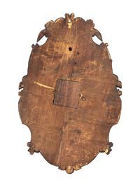A Swiss Black Forest Carved Walnut Clock