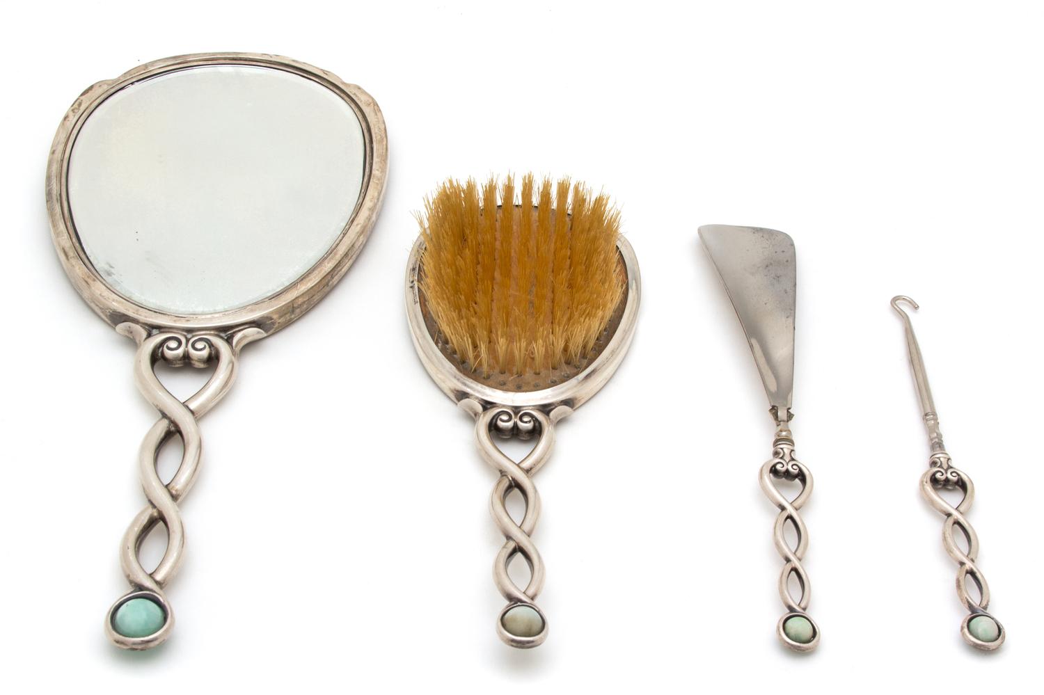 An Art Deco Silver Vanity Set, International Silver Co., New Jersey, 20th Century, with enamel and dolphin form mother-of-pearl inlay;